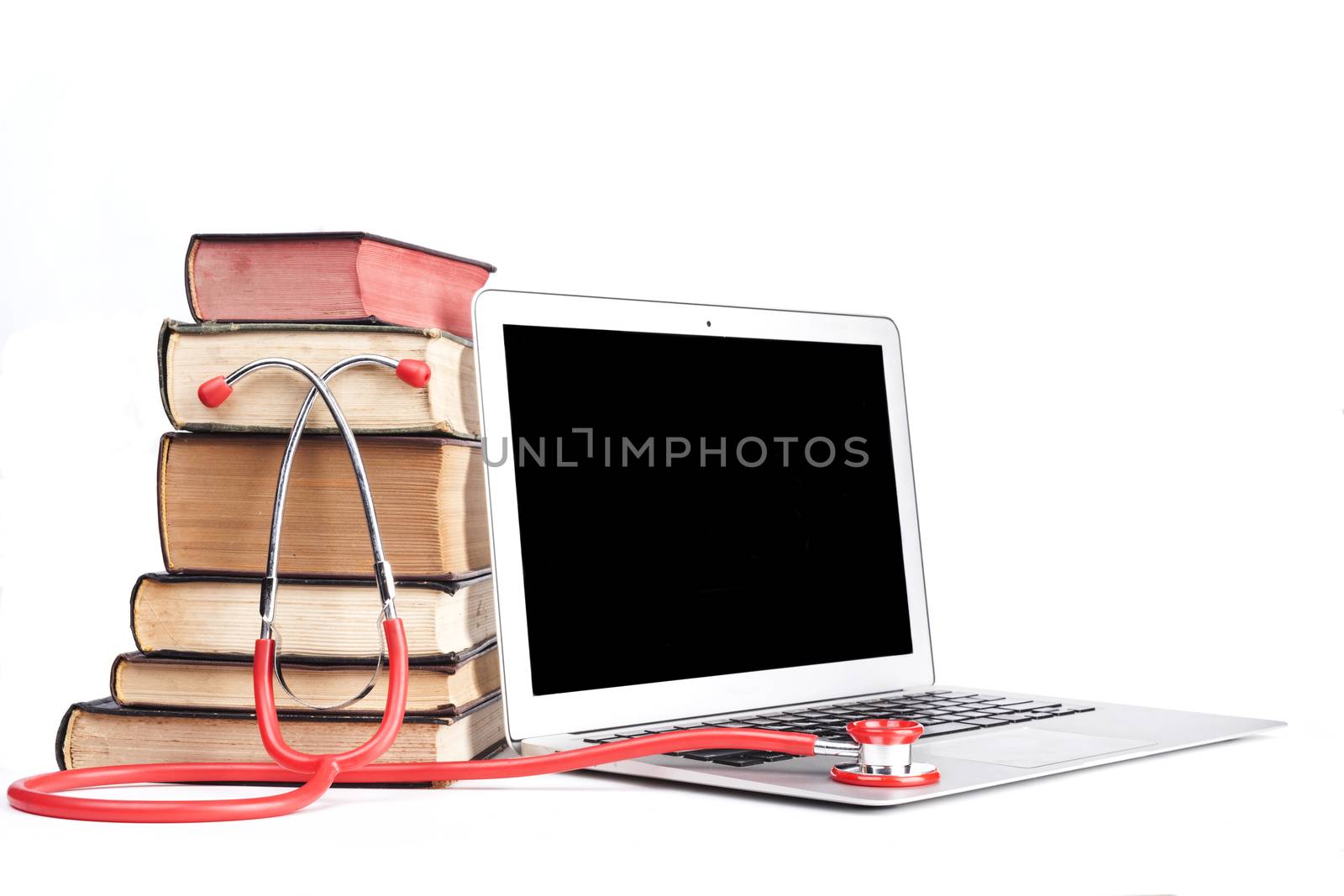 Silver laptop with red stethoscope and old pooks pile isolated on white background