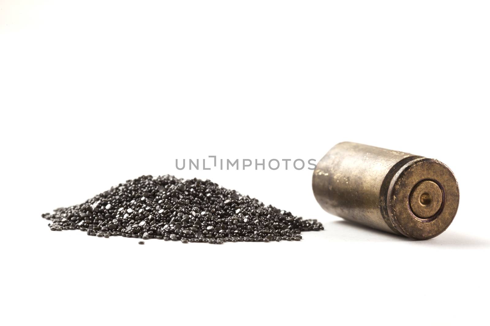 Rifle Bullet and Shel near pile of gunpowder isolated on white