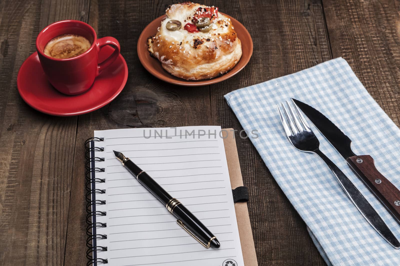 Pen and paper,coffe and some food