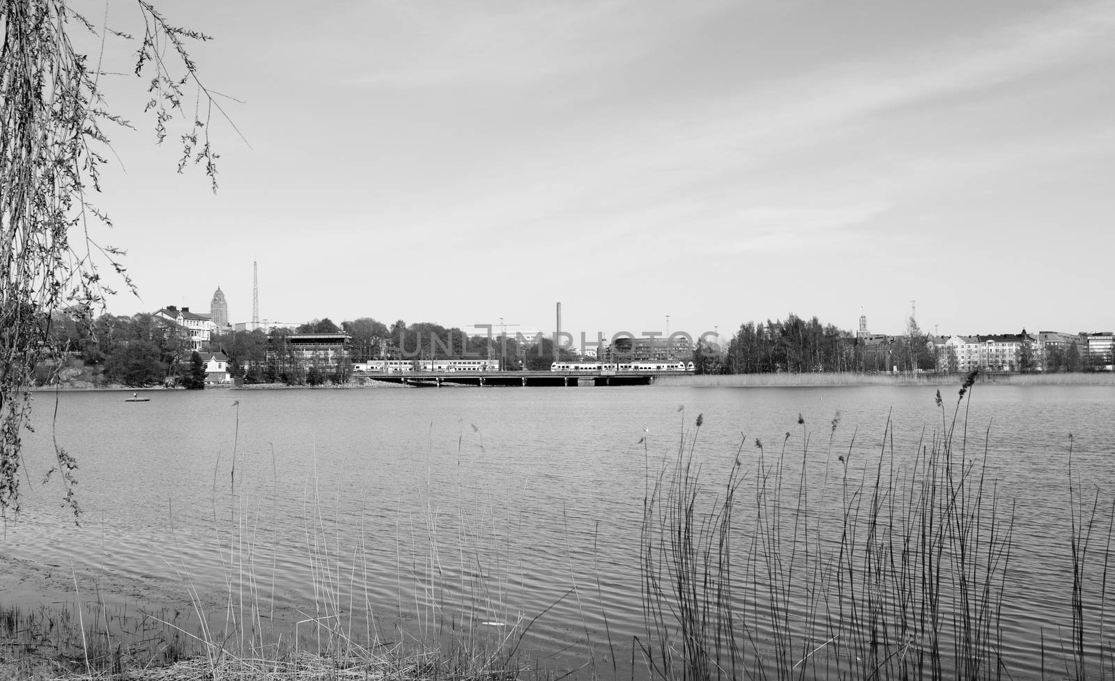 VR Pendolino trains cross a bridge on the far side of Toolo bay in Helsinki City Park - monochrome processing