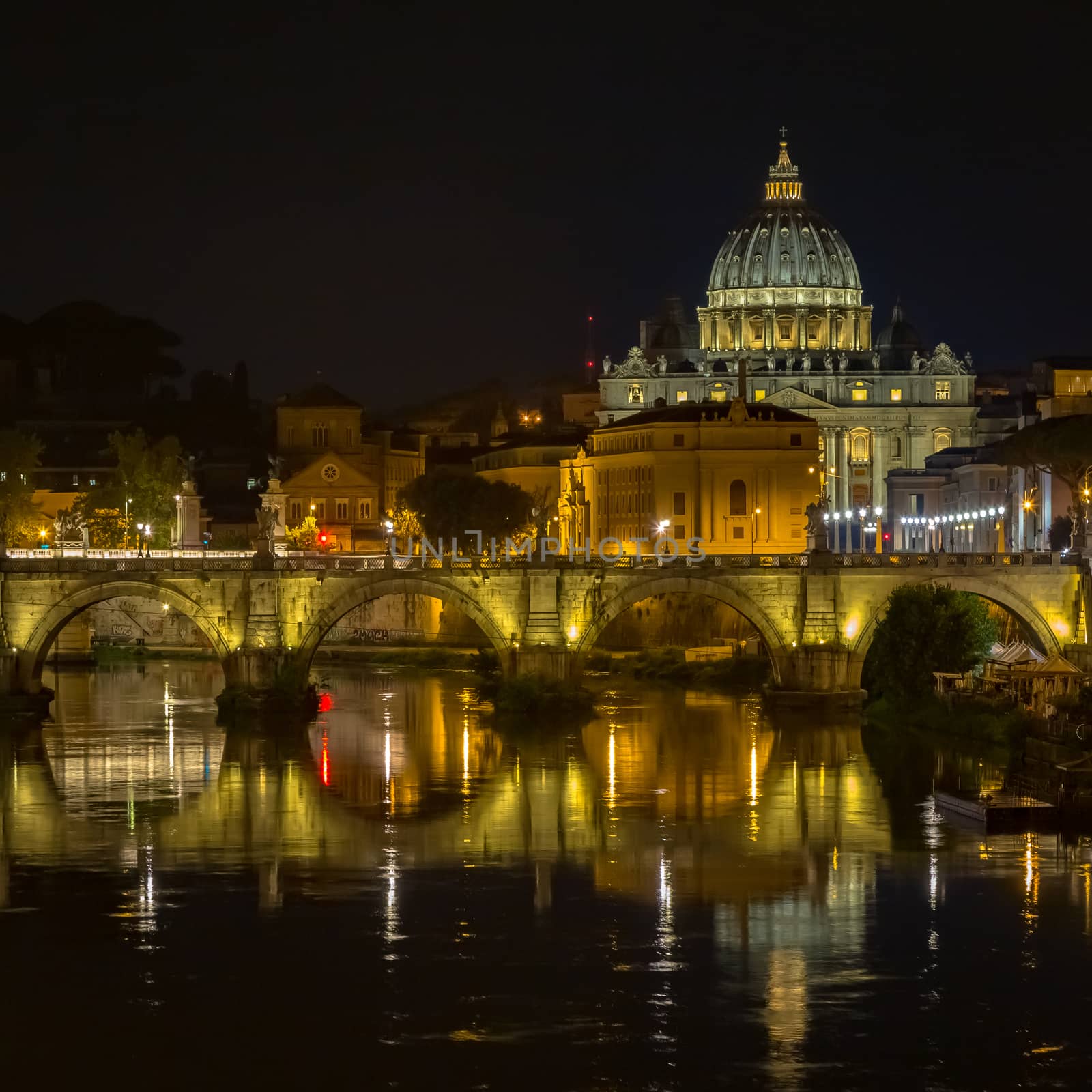 Vatican City, Rome: Saint Peter dome by night and bridge reflection on Tevere river
