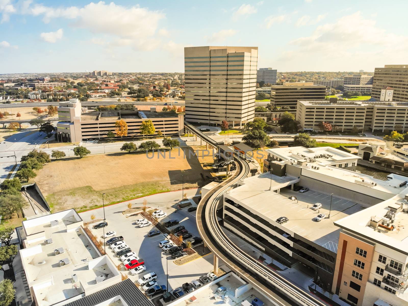 Top view light rail system and skylines in downtown Las Colinas, by trongnguyen