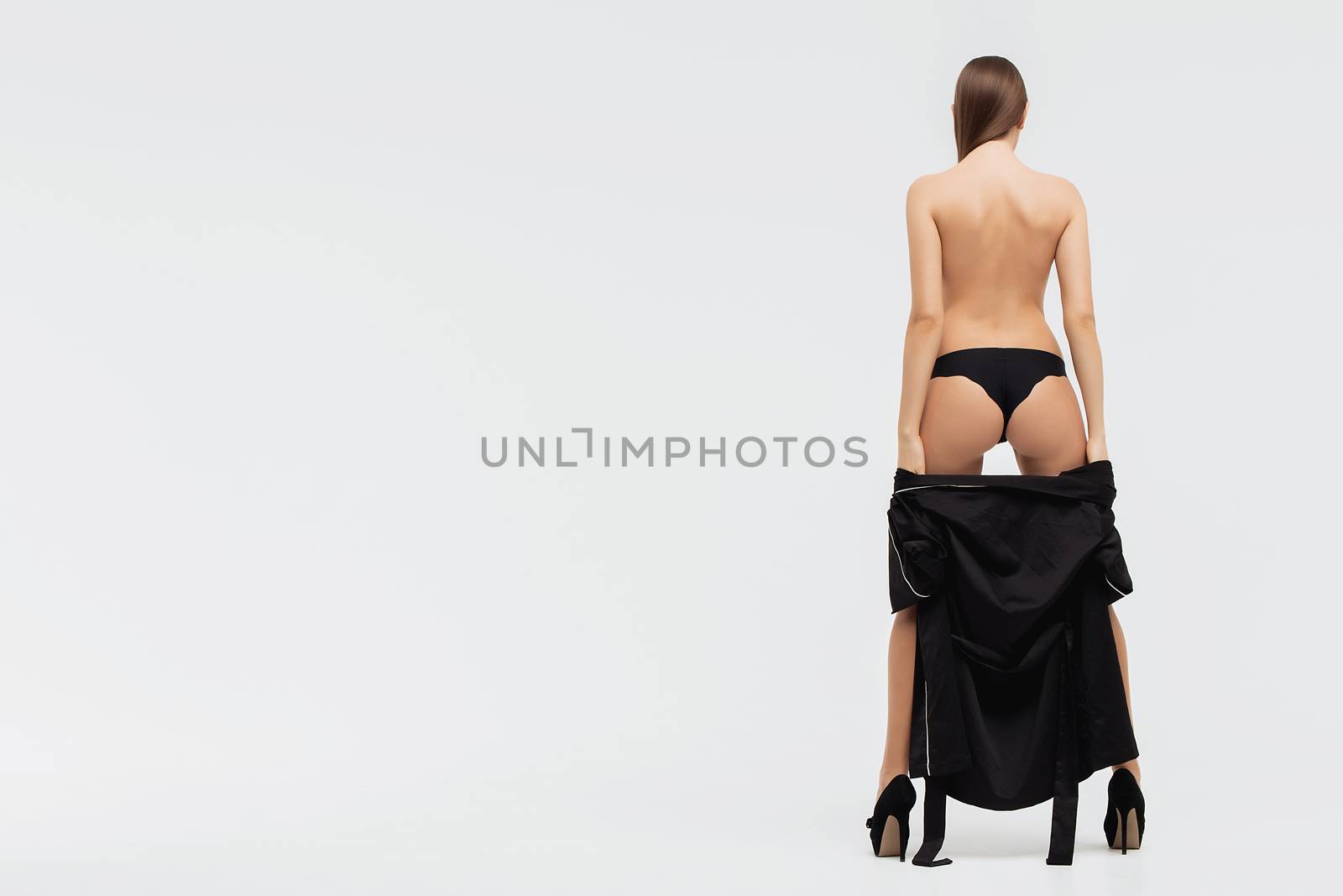 Perfect body young woman on a white background in sexy lingerie