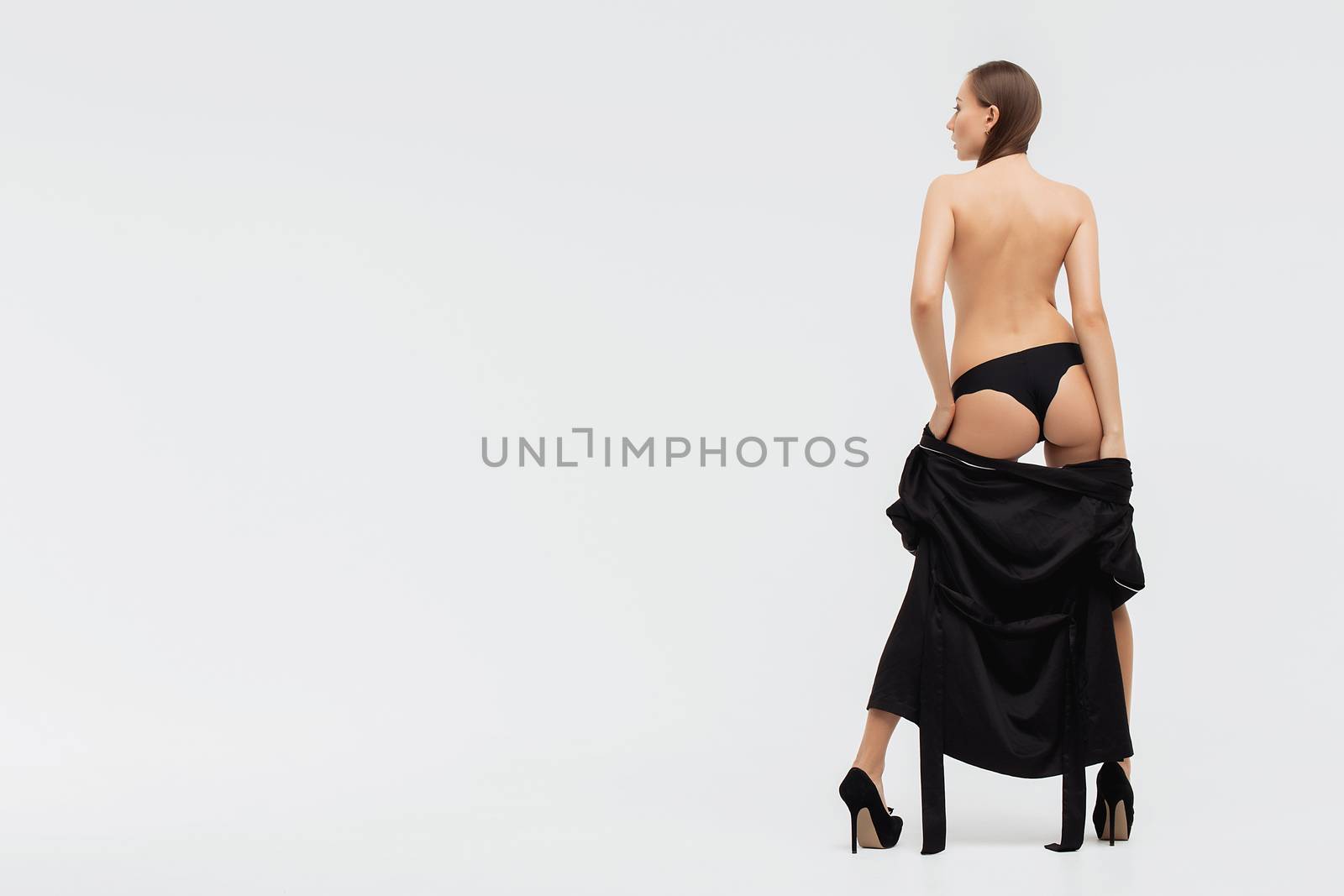 Perfect body young woman on a white background in sexy lingerie