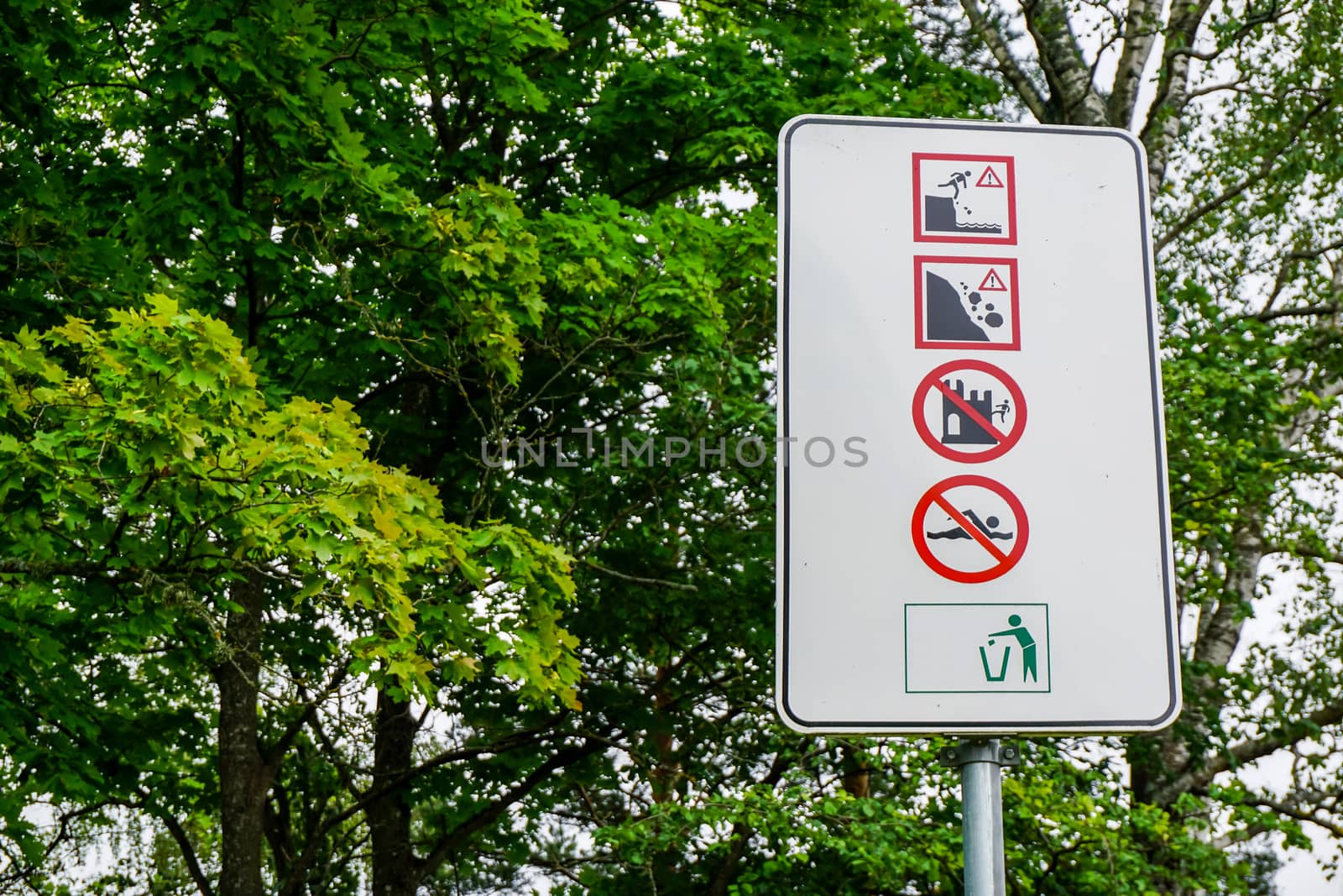 Sign at Koknese castle. Warning board in green park for information, Koknese, Latvia.