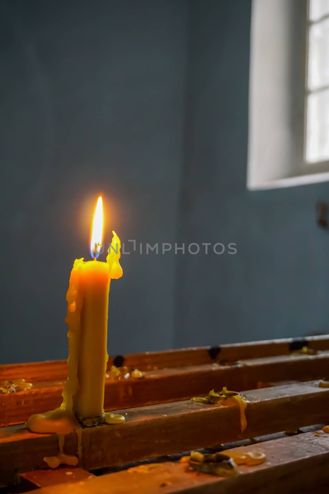 Burning candle at Koknese Evangelical Lutheran Church. Evangelic Lutheran Church in Koknese, Latvia. Interior of Koknese church. Church was built in 1687. 