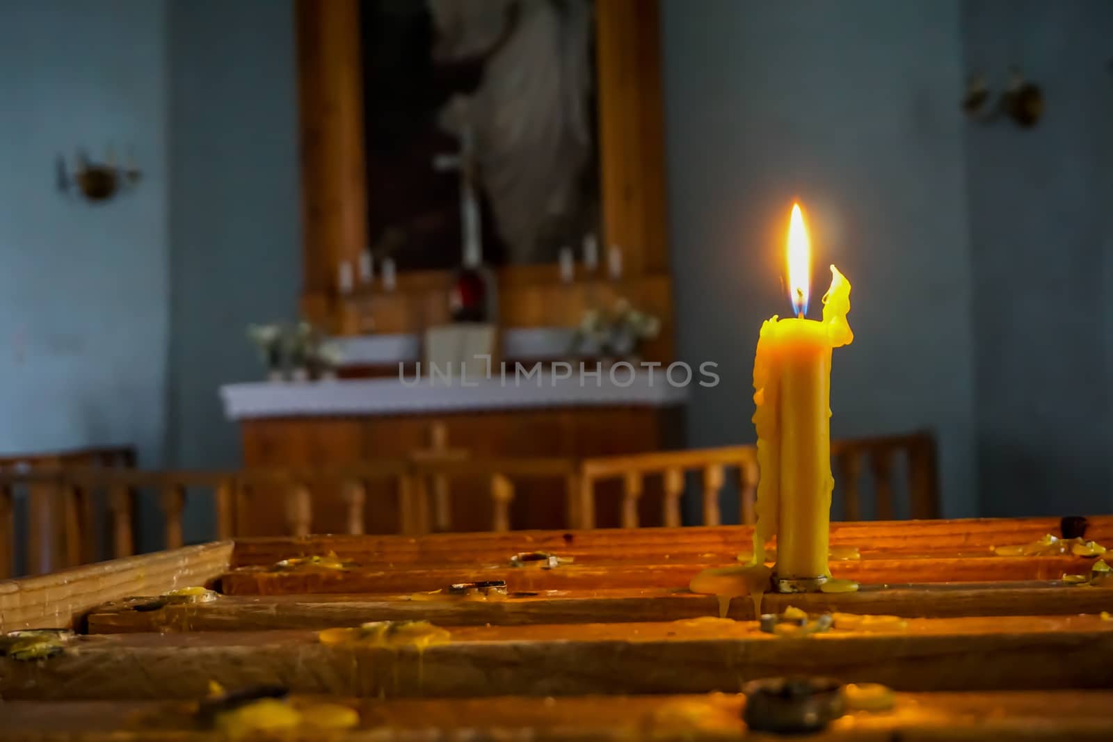 Burning candle at Koknese Evangelical Lutheran Church. Evangelic Lutheran Church in Koknese, Latvia. Interior of Koknese church. Church was built in 1687. 