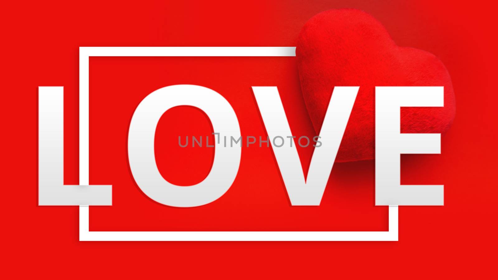 Valentines day background with soft toy heart and word Love in white color on red background. Top view. For banner, cards design