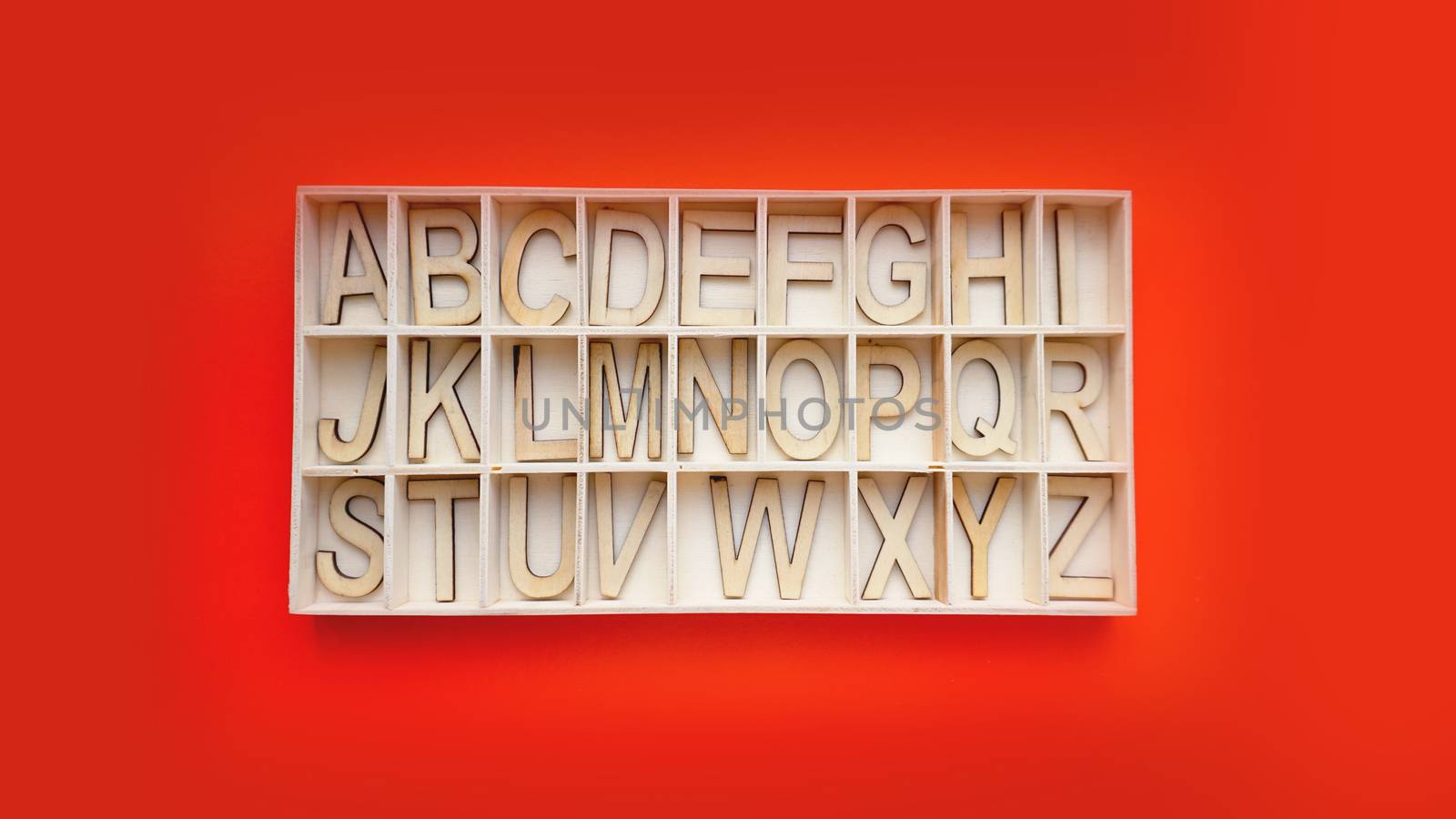 Wooden alphabet blocks with letters - box on a red background. Learning english by natali_brill