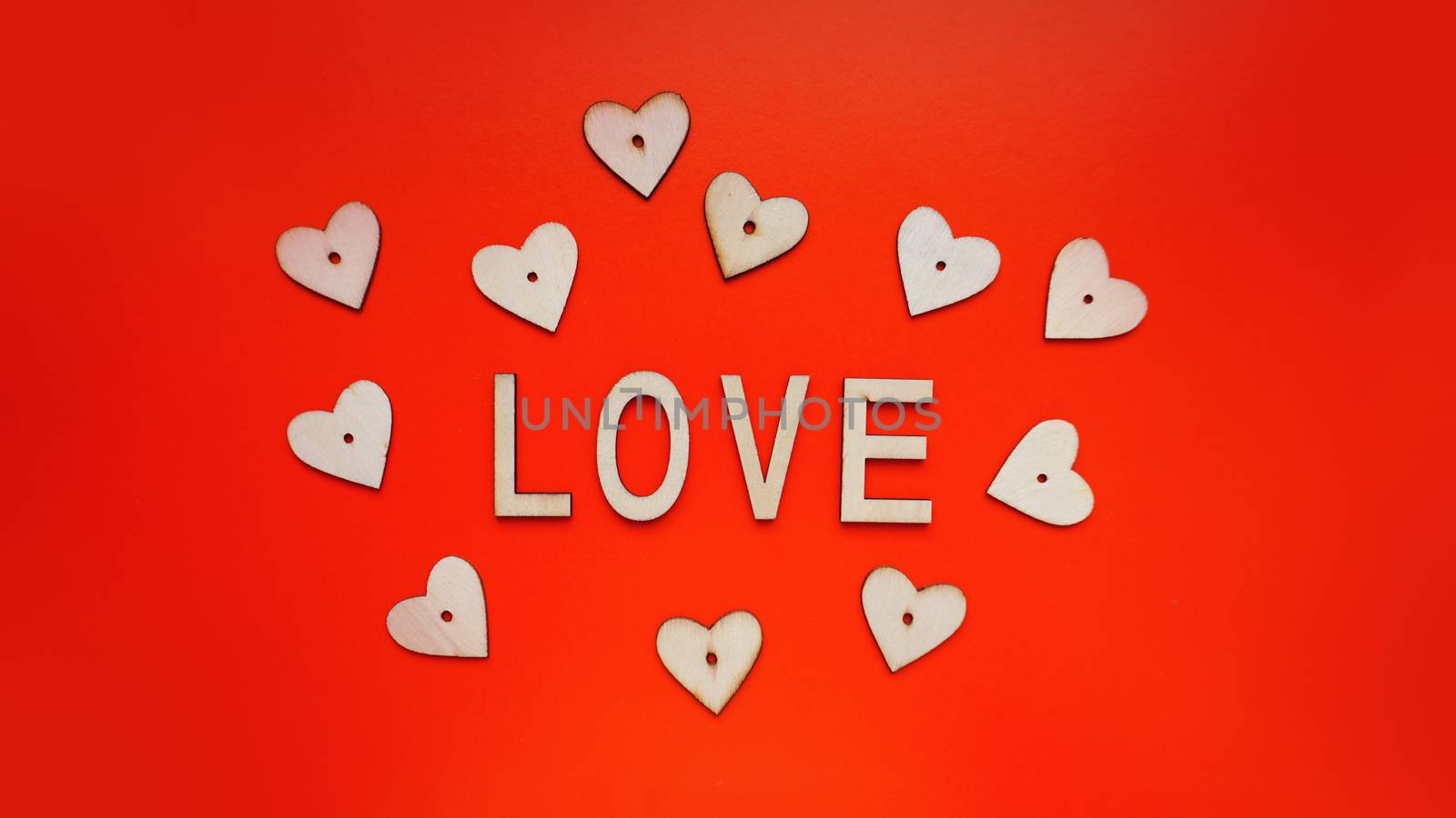 Valentines Day background with red hearts and letters love - made of wood on red by natali_brill