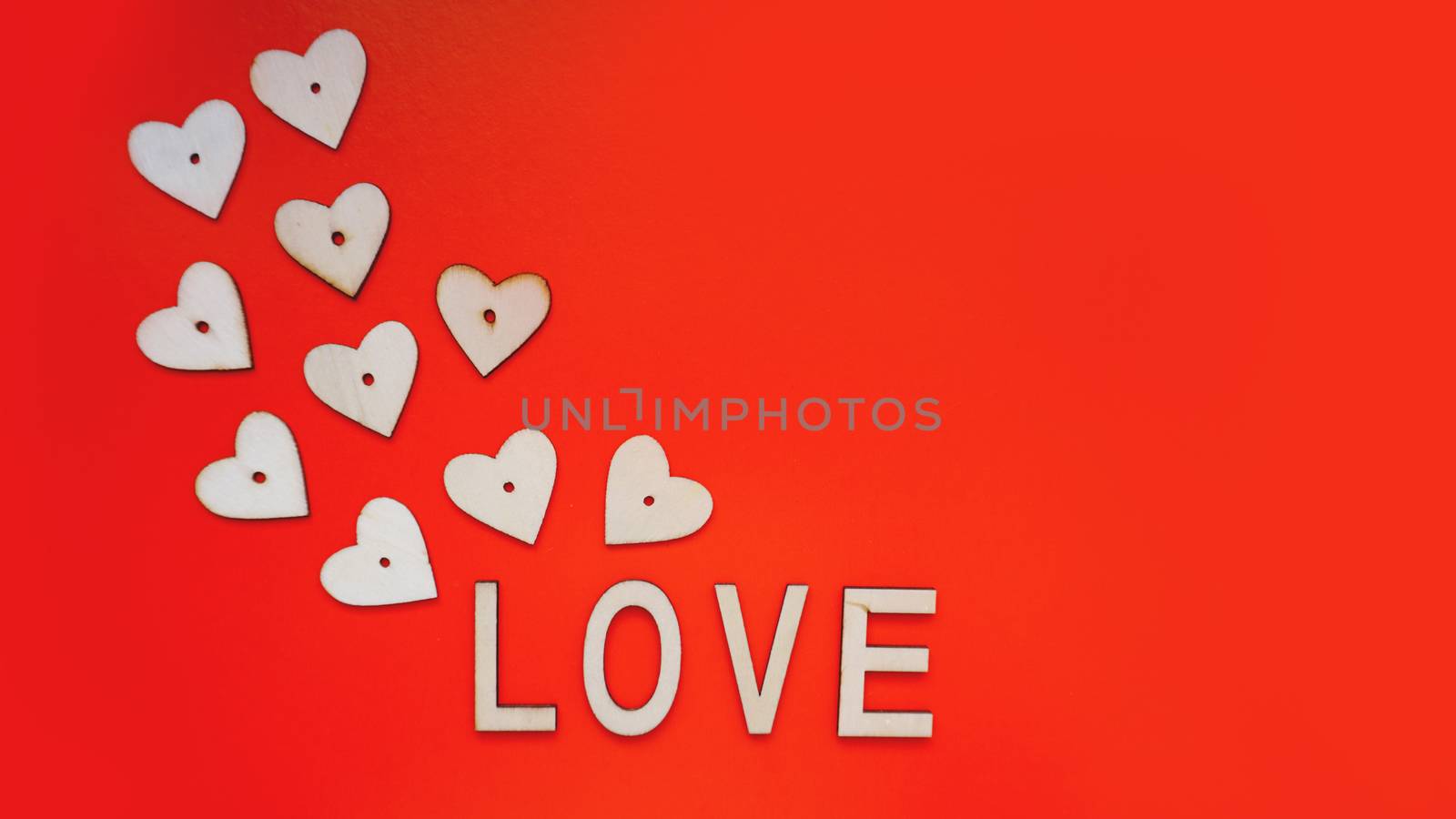 Valentines Day background with red hearts and letters love - made of wood on red by natali_brill