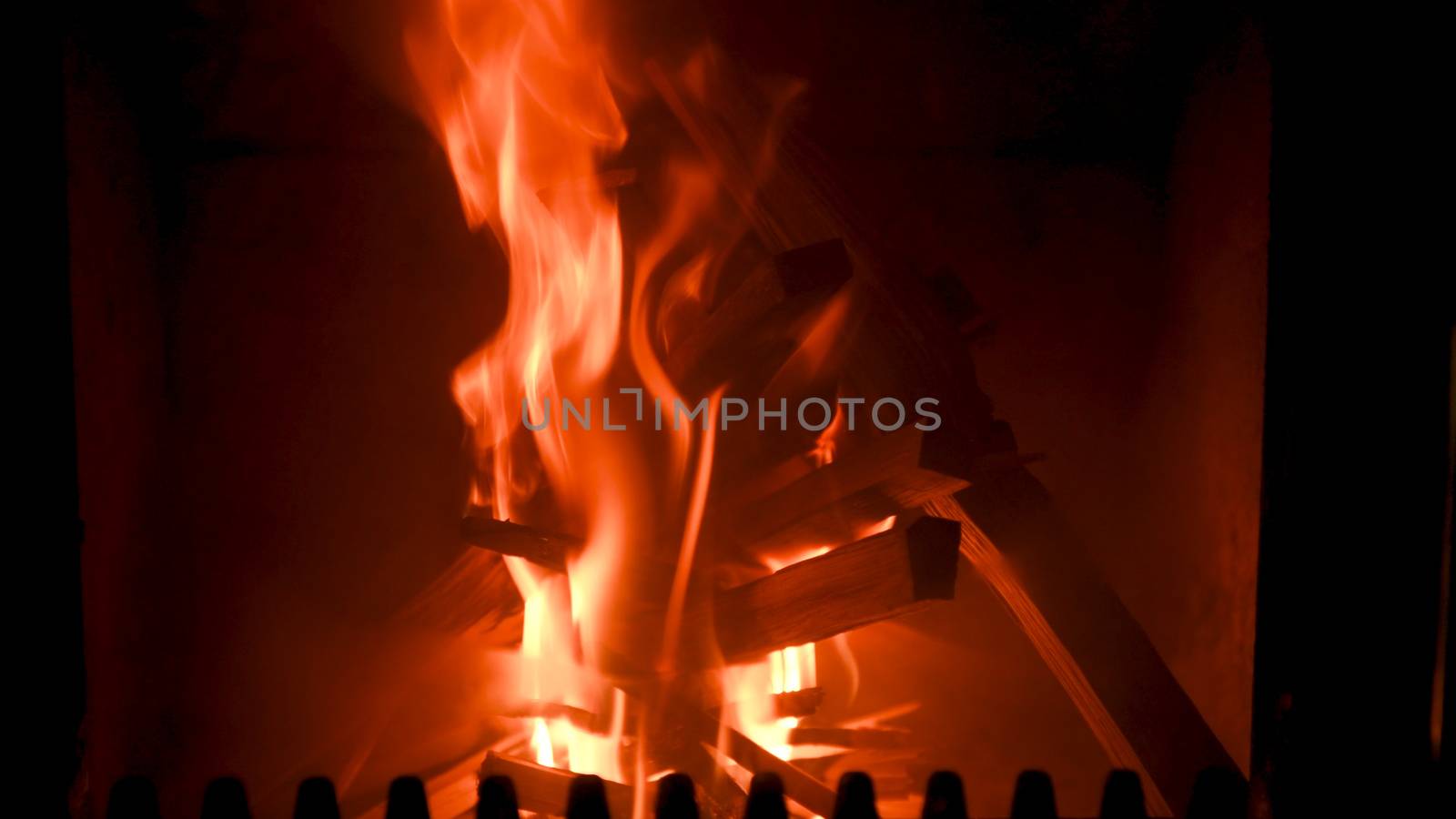 Fire in stove, close up, firewood burning, detail interior scene, winter concept
