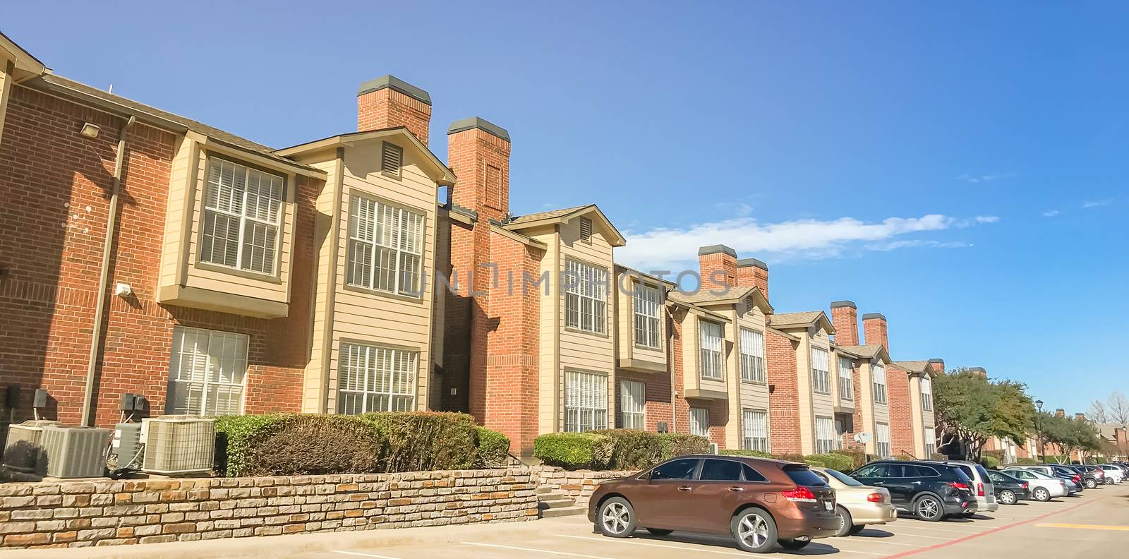 Panoramic view exterior of apartment building in suburbs Dallas, by trongnguyen