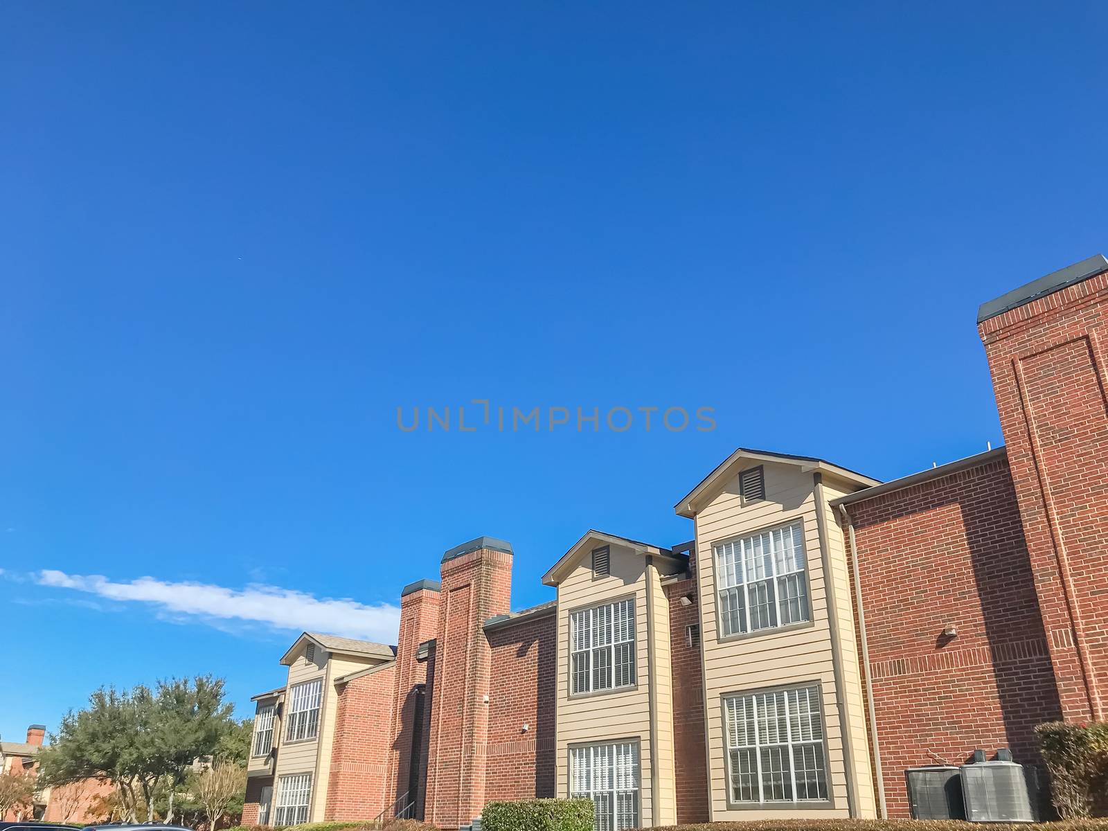 Typical apartment building with blue sky in suburban Dallas, Texas, USA