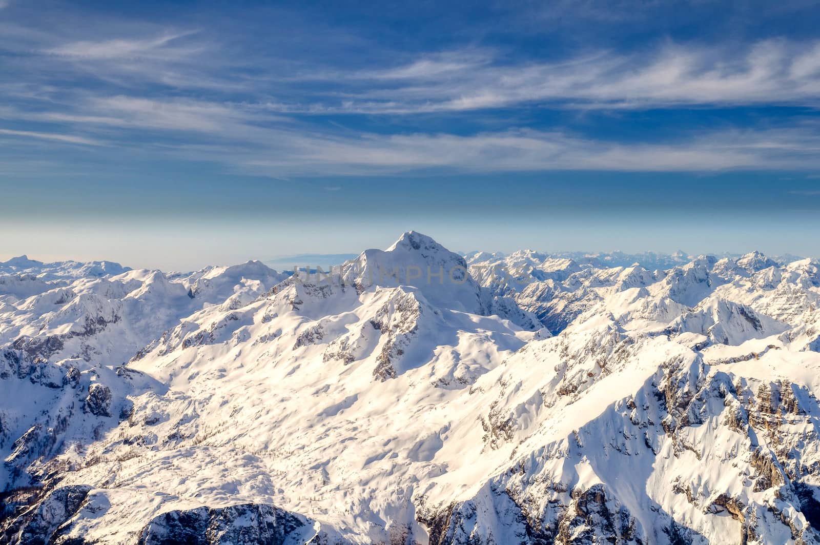 Triglav in Julian Alps in winter, aerial landscape panorama of mountains covered with snow, highest mountain in Slovenia