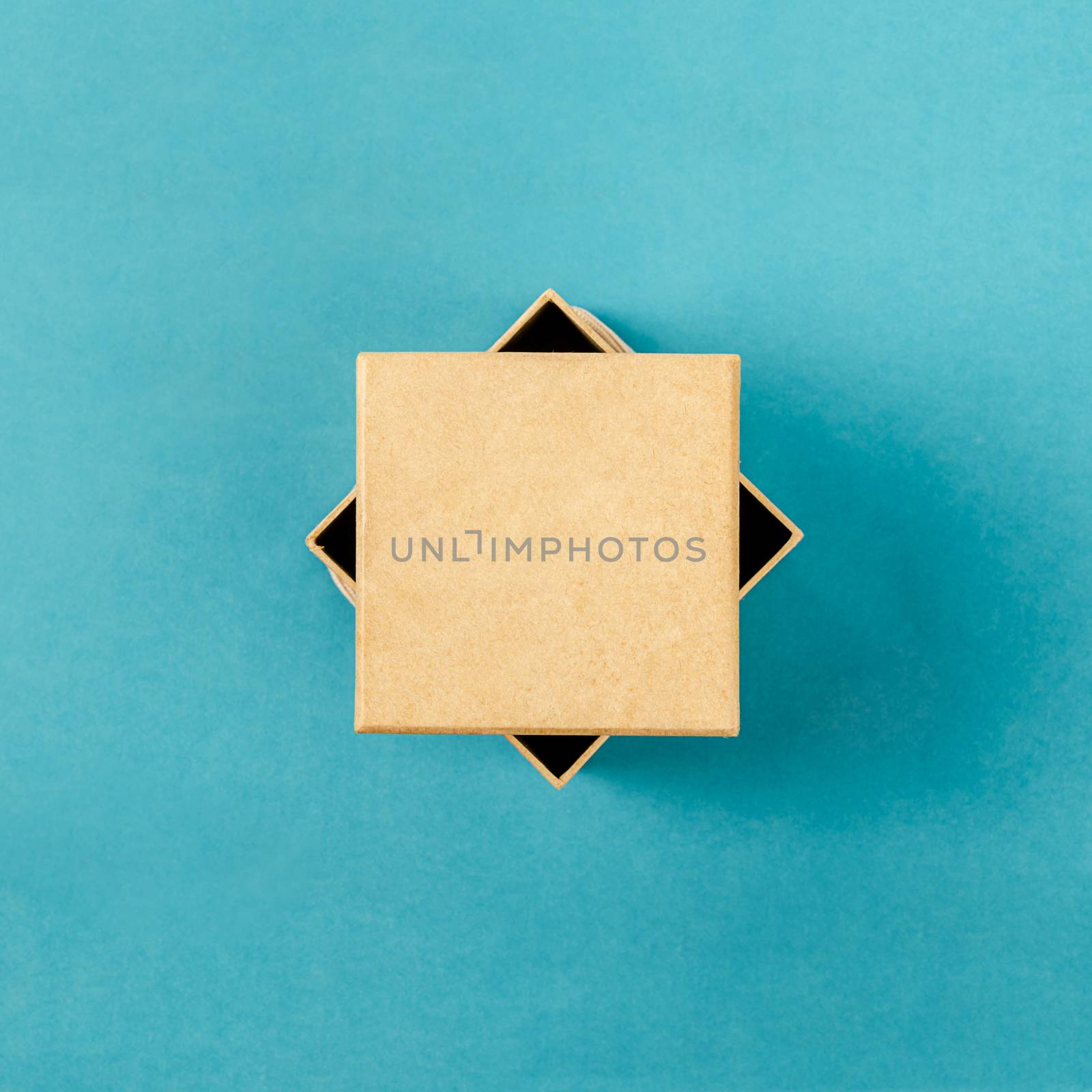 Top view of a present box package isolated on blue background.