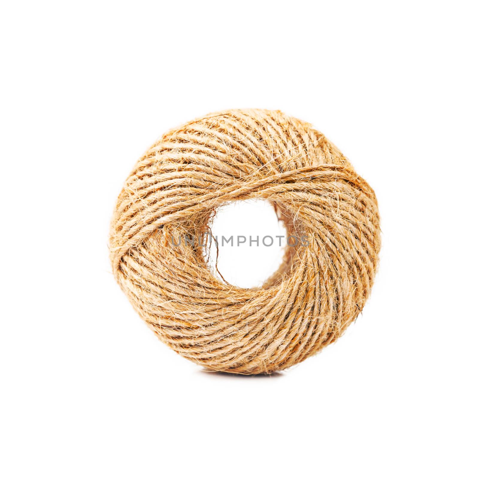 Hemp rope roll isolated on white. by Gamjai