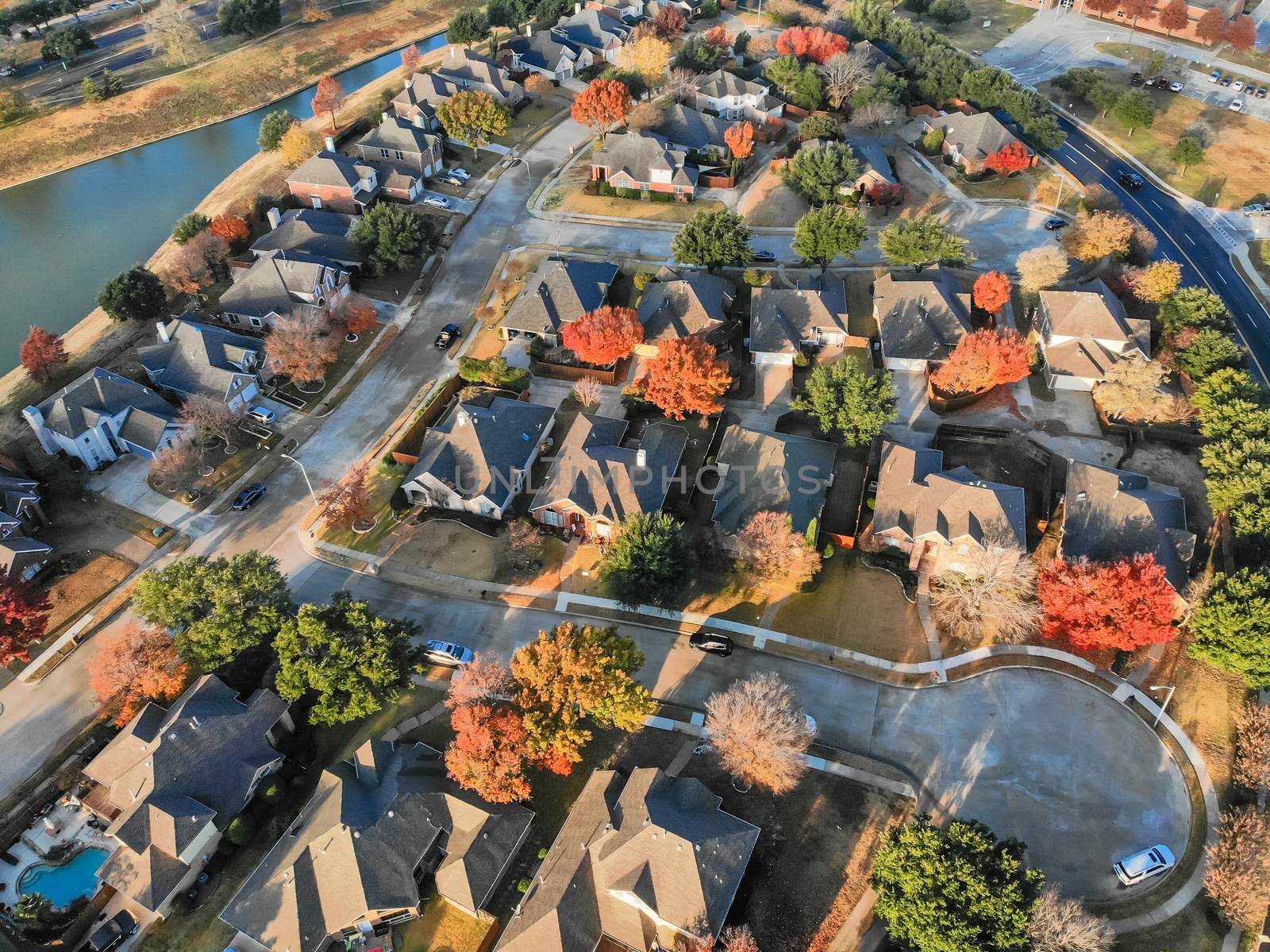 Aerial view lakefront neighborhood with cul-de-sac dead-end street near Dallas, Texas. Morning autumn season with colorful fall foliage leaves
