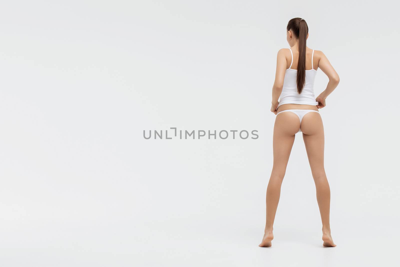 Perfect body young woman on a white background in sexy lingerie