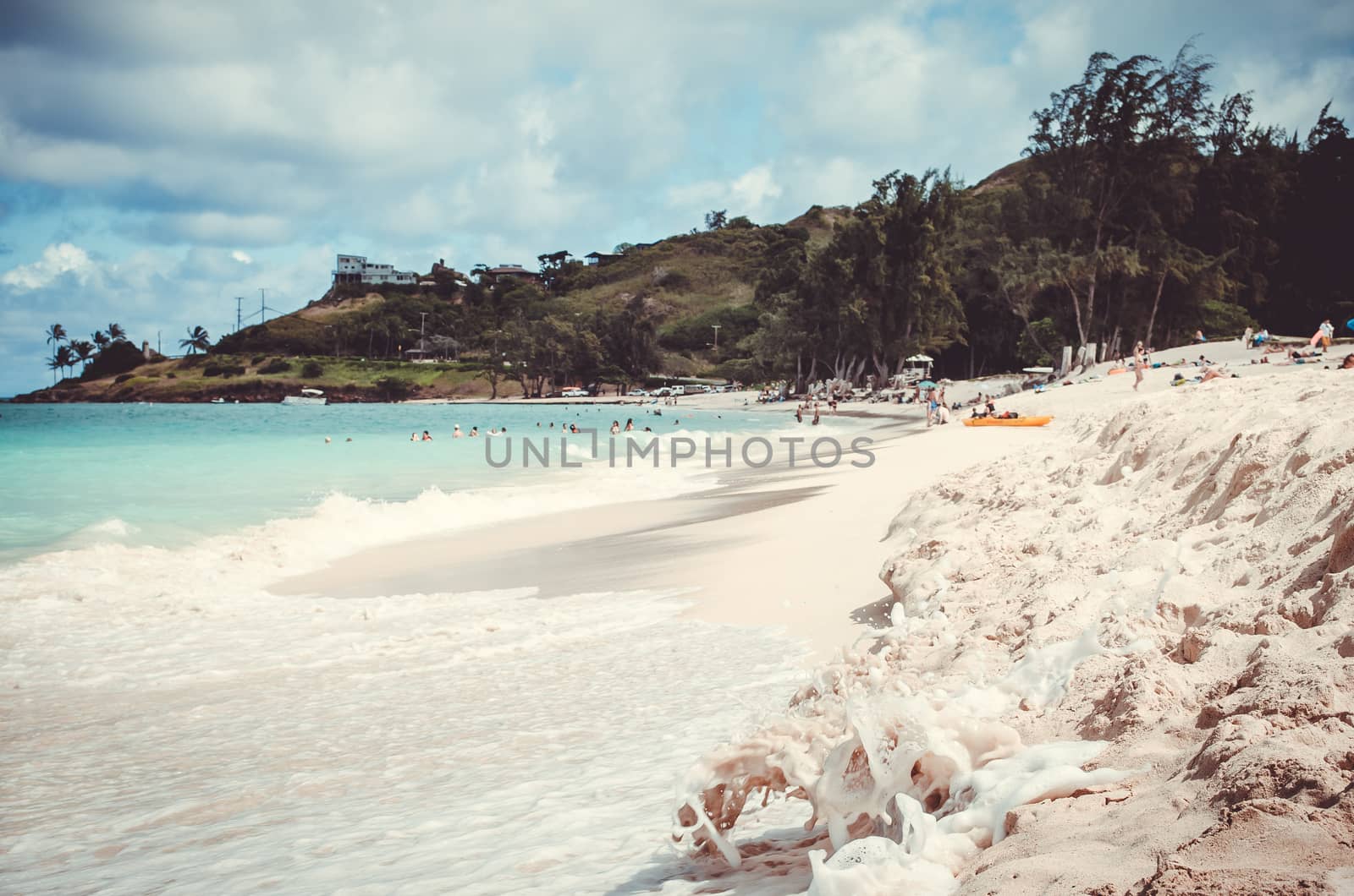 Idilic white sand beach with green hill at the back in Hawaii, US by mikelju