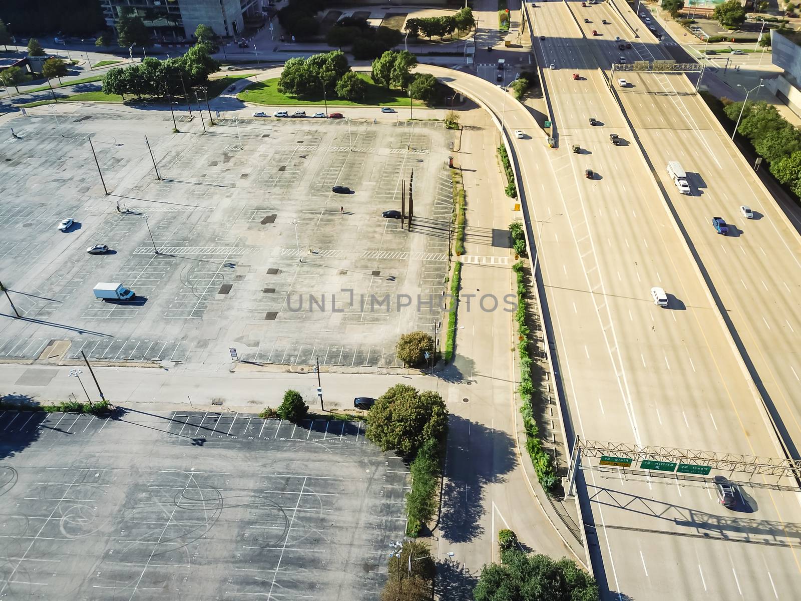 Top view vacant parking lots near highway in downtown Dallas, Texas, America