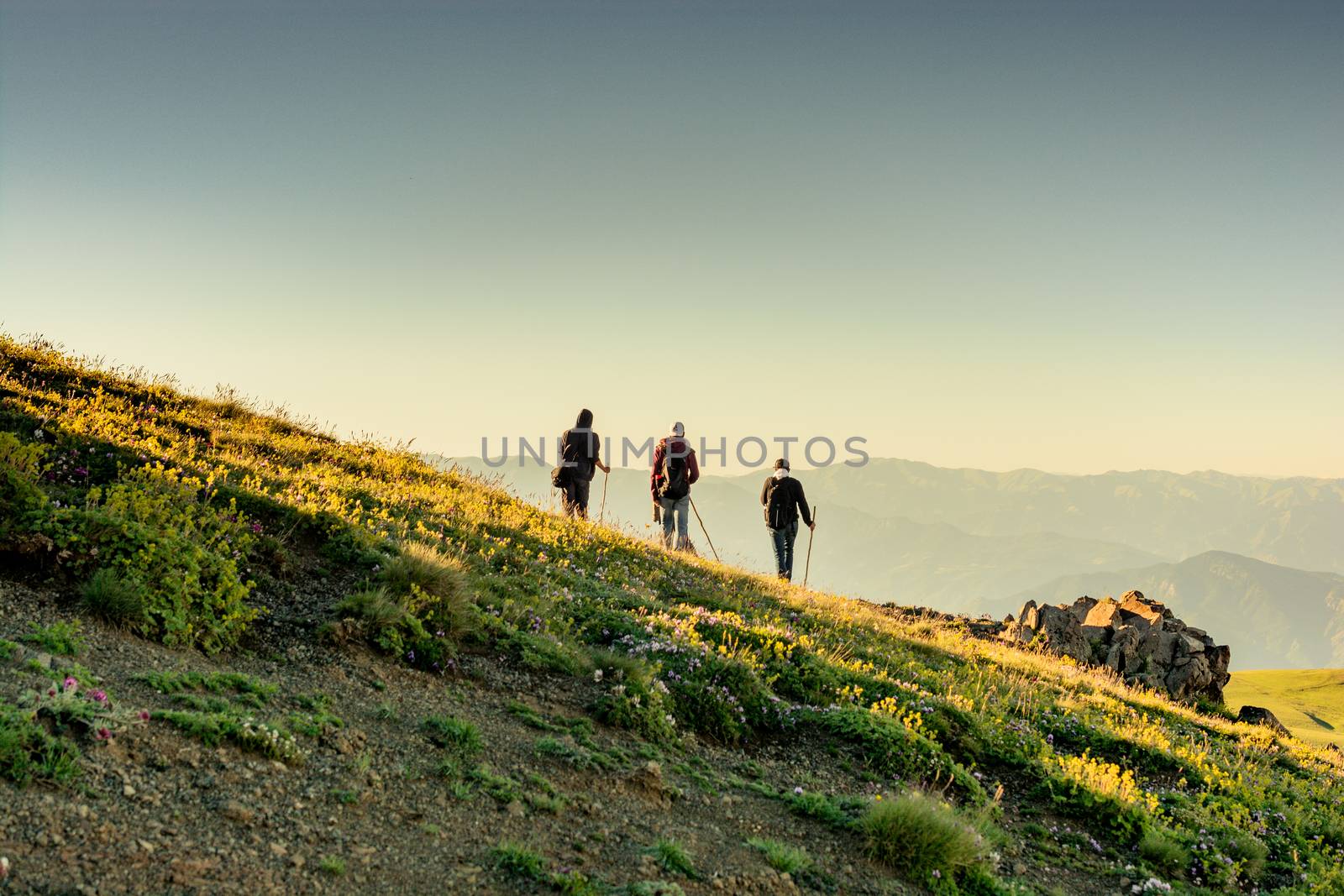 hikers with backpacks and trekking poles walking in Turkish highland