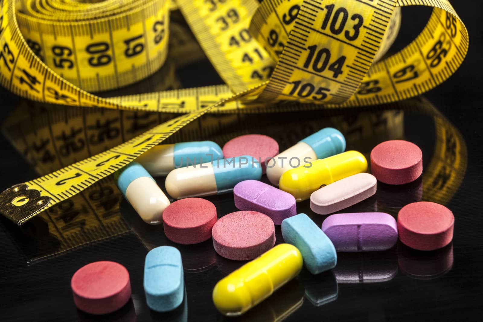 Pills isolated on black background with reflexion