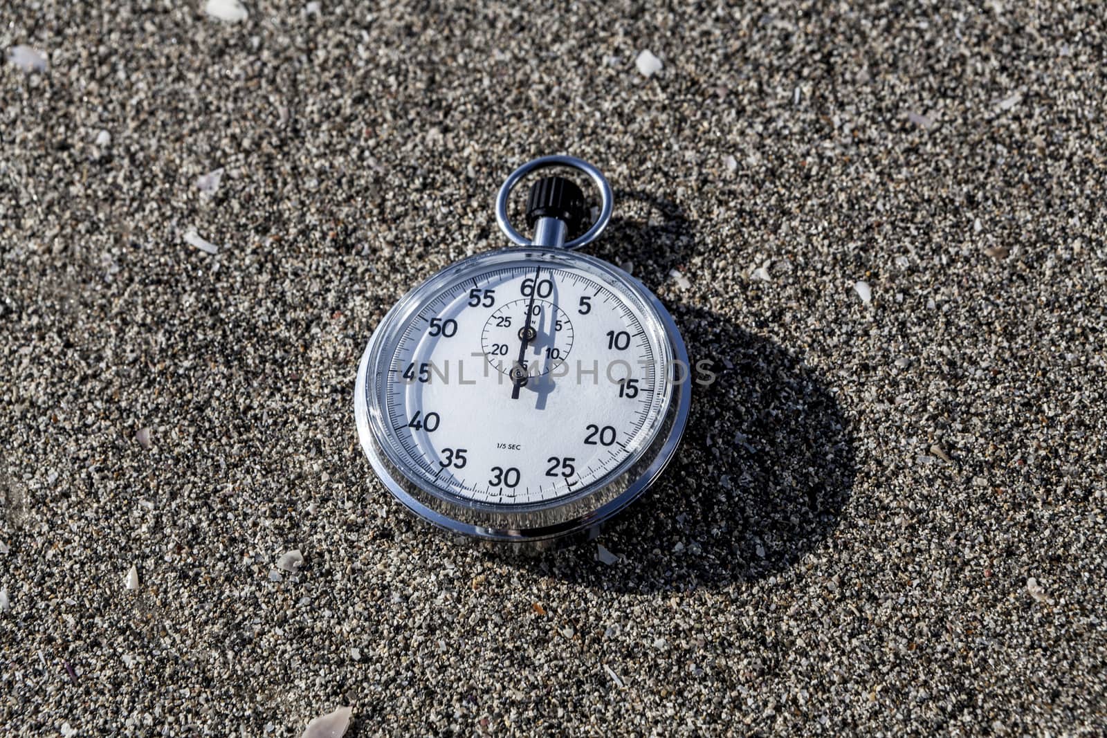 analog Stopwatch on wet sea sand