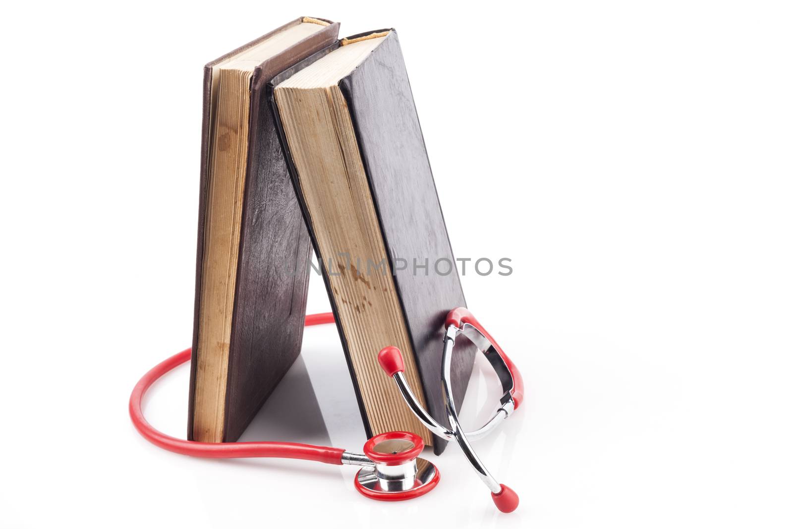 Two Books with Red Stethoscope on White Background With Reflection