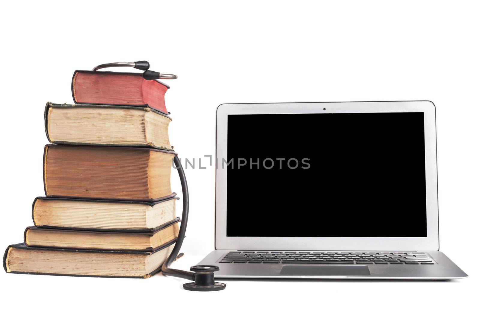 Old Books black stethoscope ans silver laptop isolated on white background