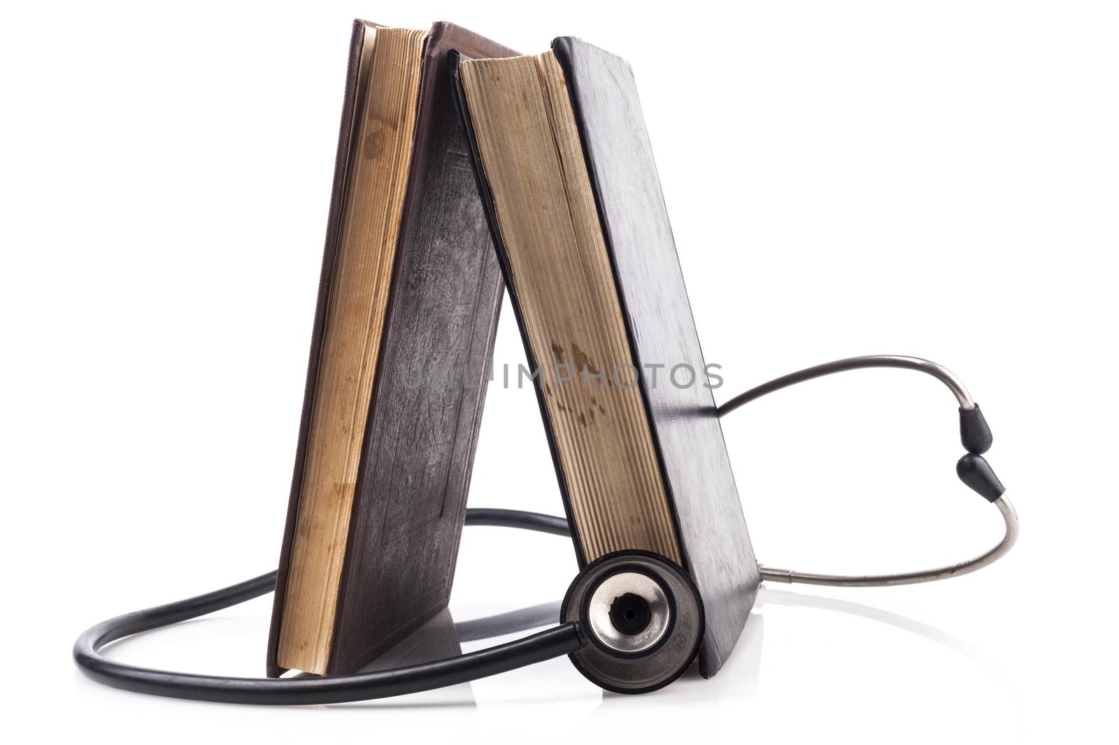 Two Books with Black Stethoscope on White Background With Reflection