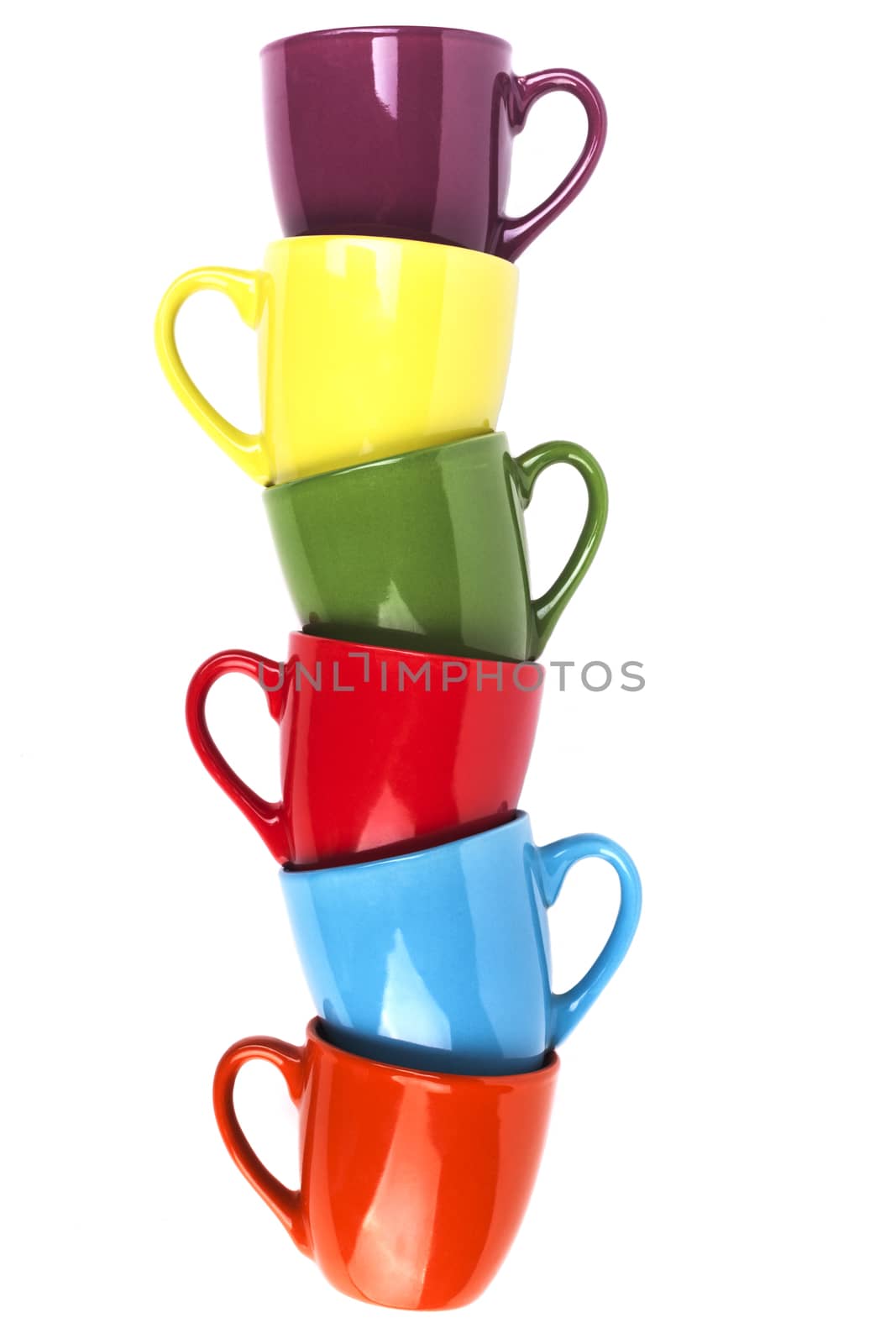 Colored coffee mugs pile isolated on white background