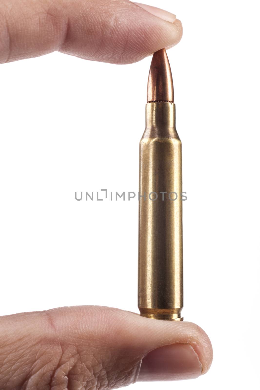 Fingers Holding Single Rifle Bullet Isolated On White Background