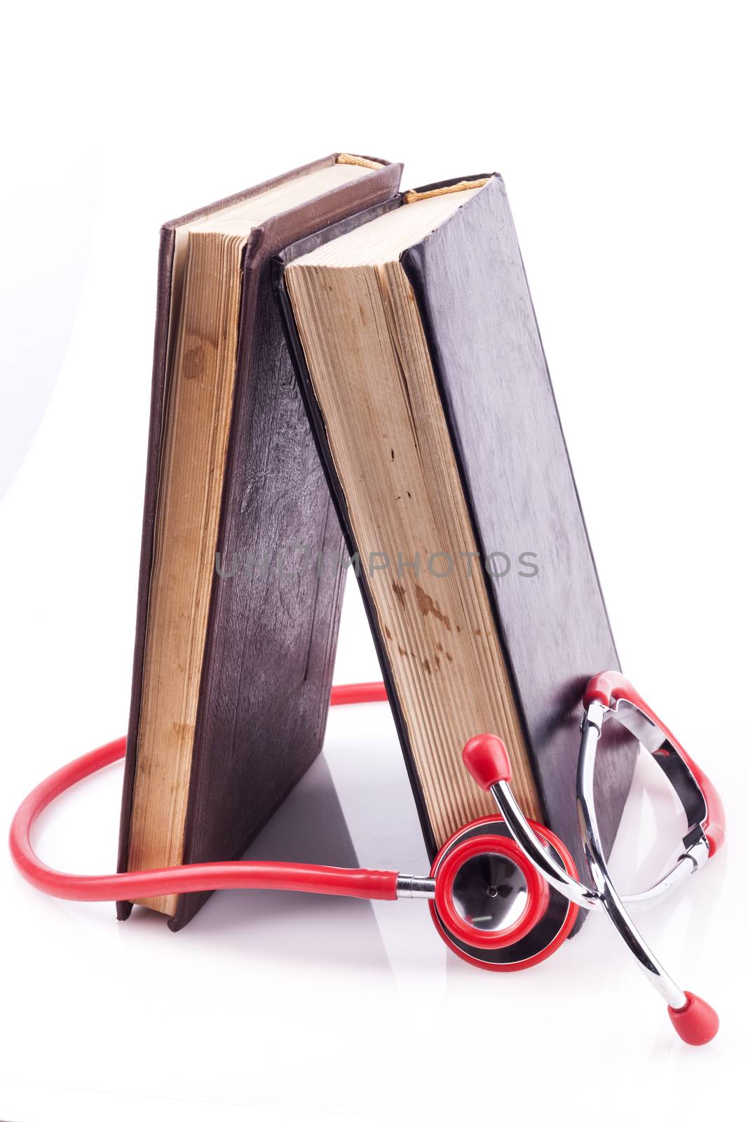Red Stethoscope with Two Books on White background and Reflection