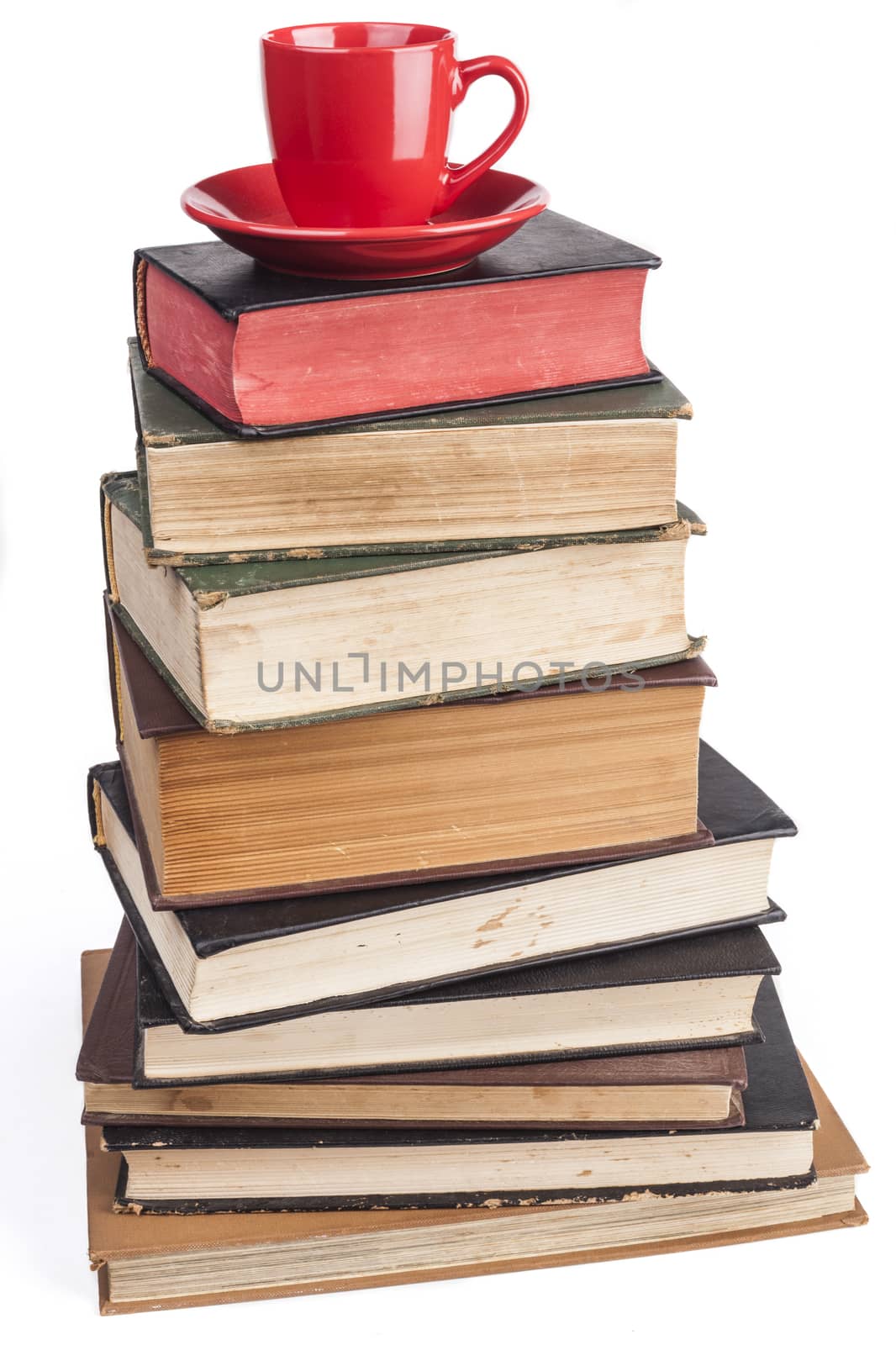 Old Books  and red coffee mug isolated on white background