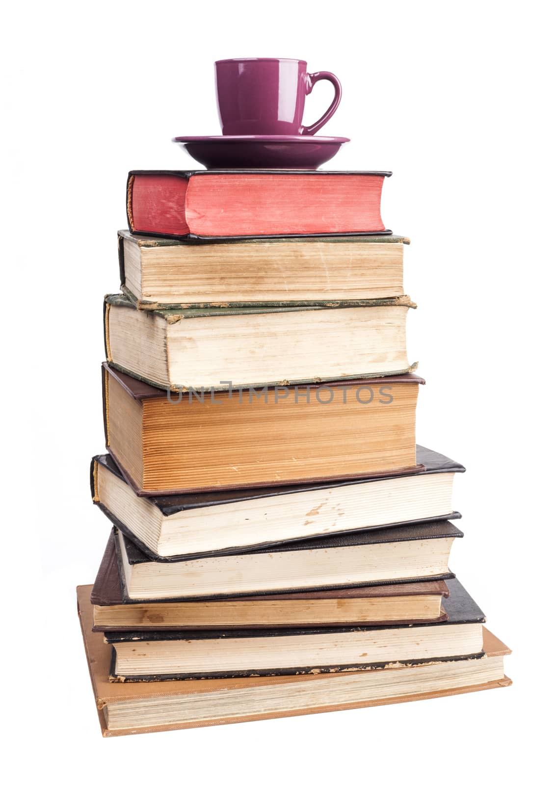 Old Books  and purple coffee mug isolated on white background