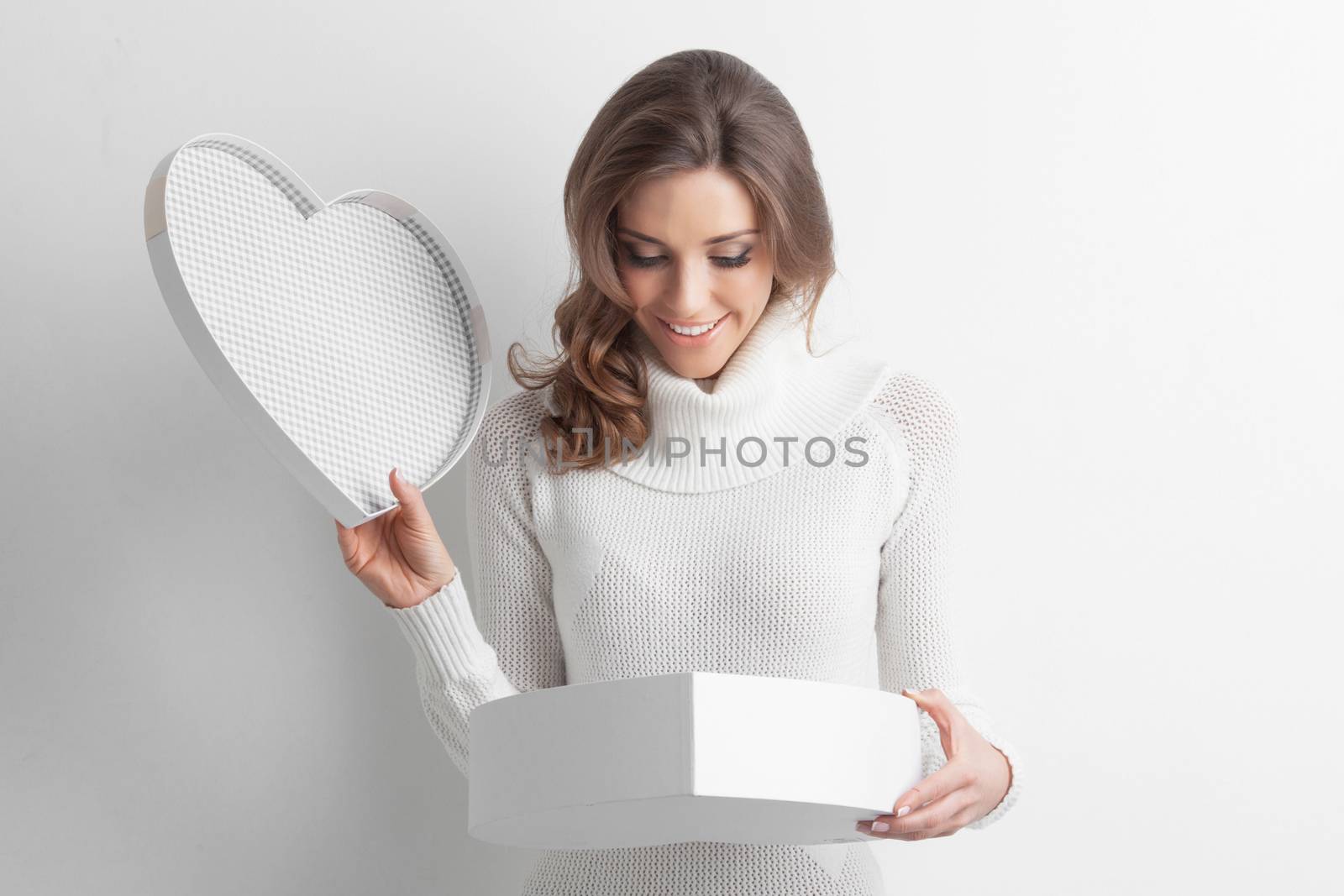 Pretty girl open heart shaped gift box on Valentines day
