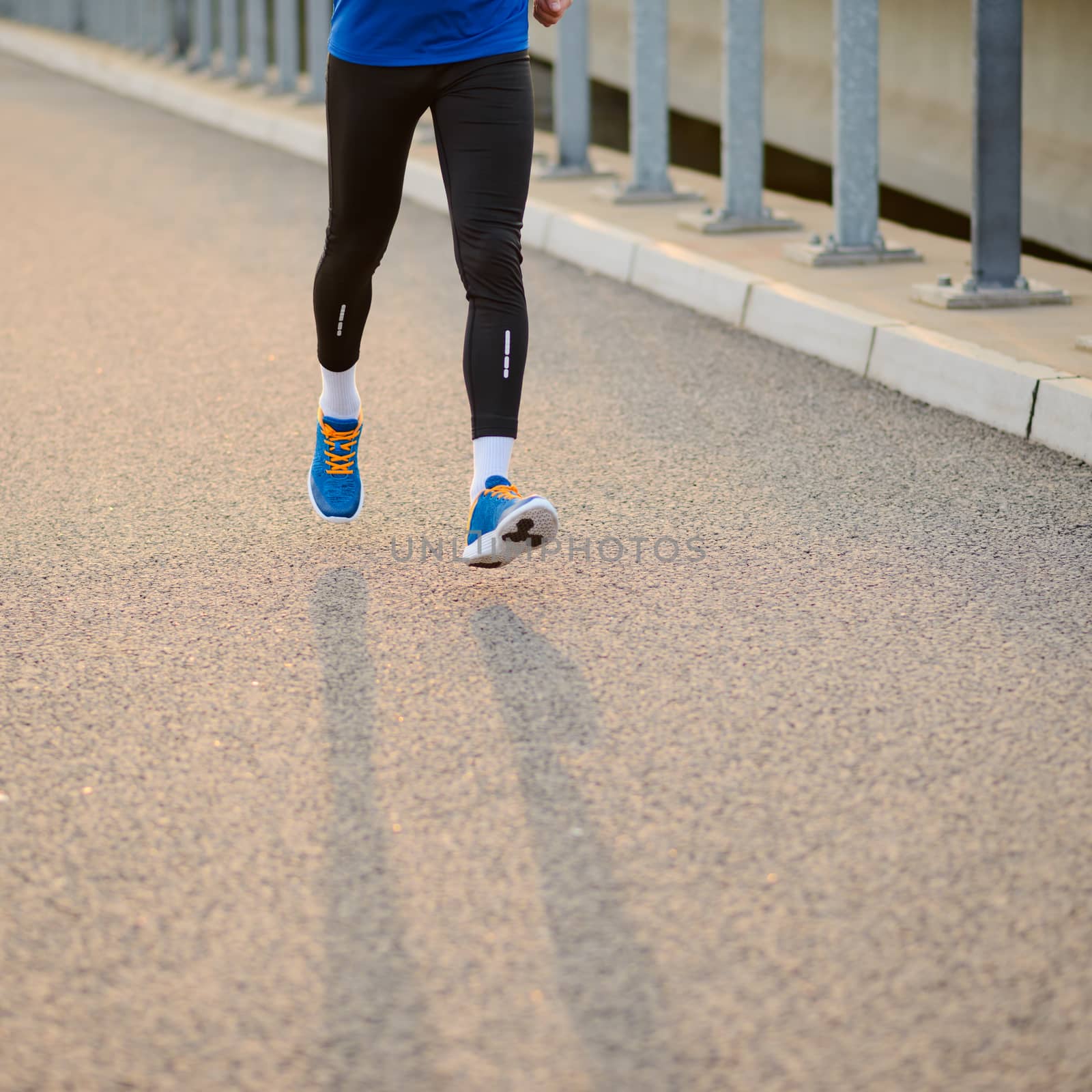 Close-up of Male Sports Mans Legs Running at Sunset. Healthy Lifestyle and Sport Concept. by maxpro