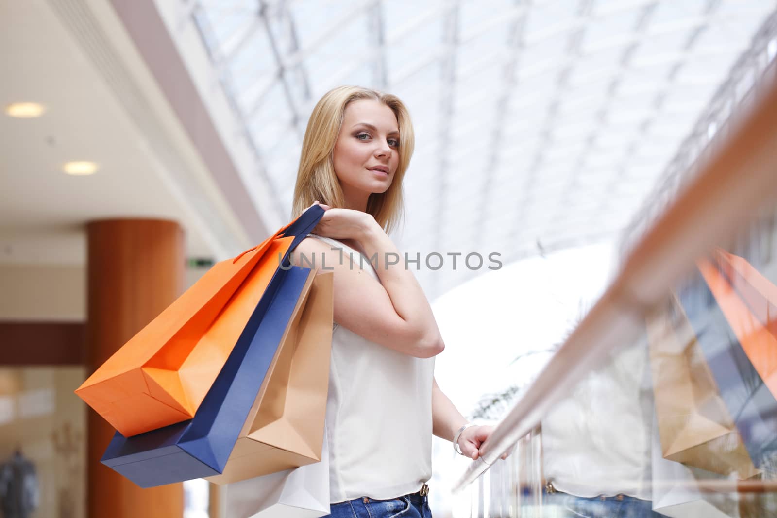 Fashion shopping woman walking with bags in shopping mall