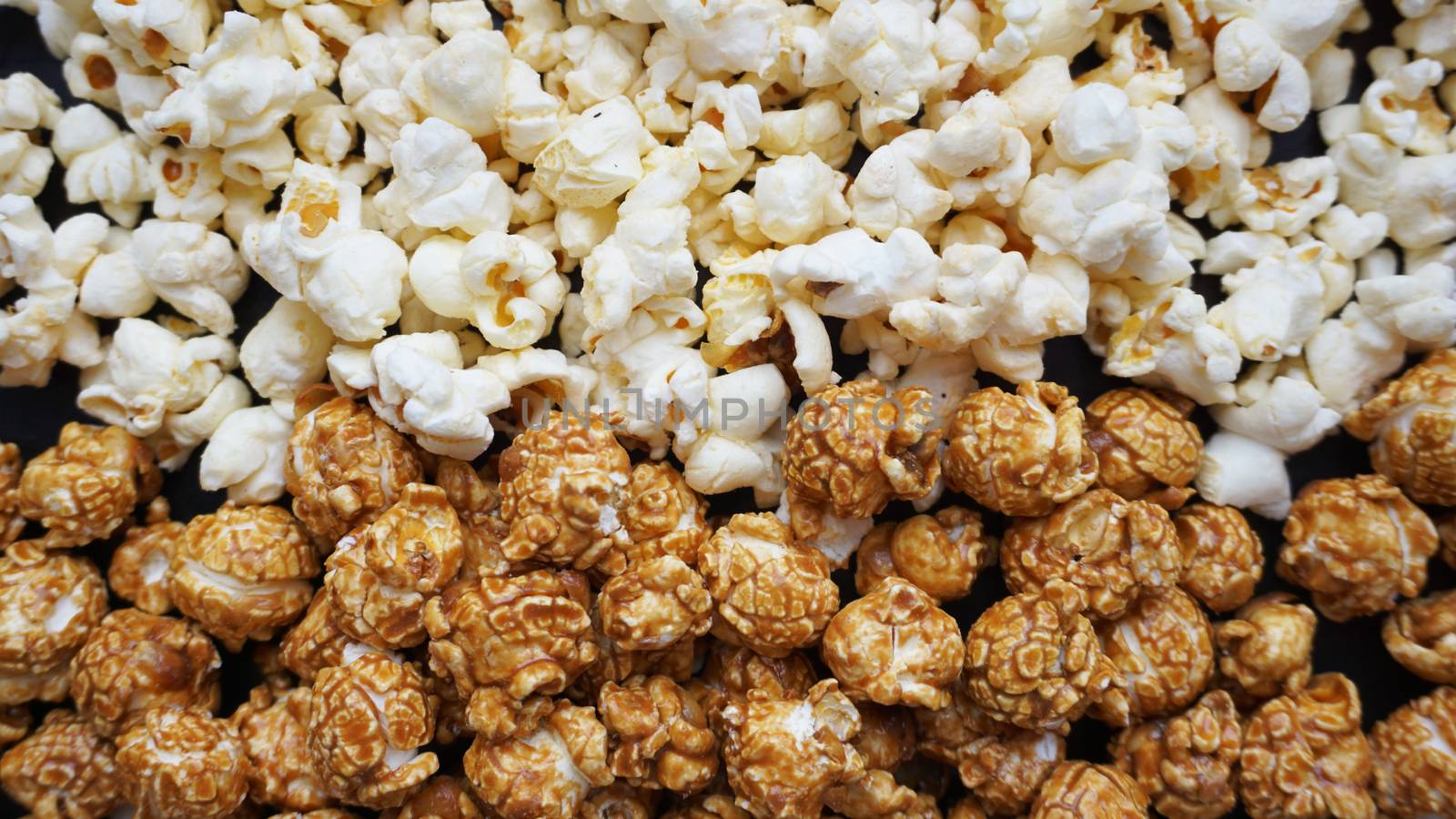 Assorted popcorn set background. Sweet and salty popcorn on black background. Still life, top view, flat lay. Concept cinema and entertainment