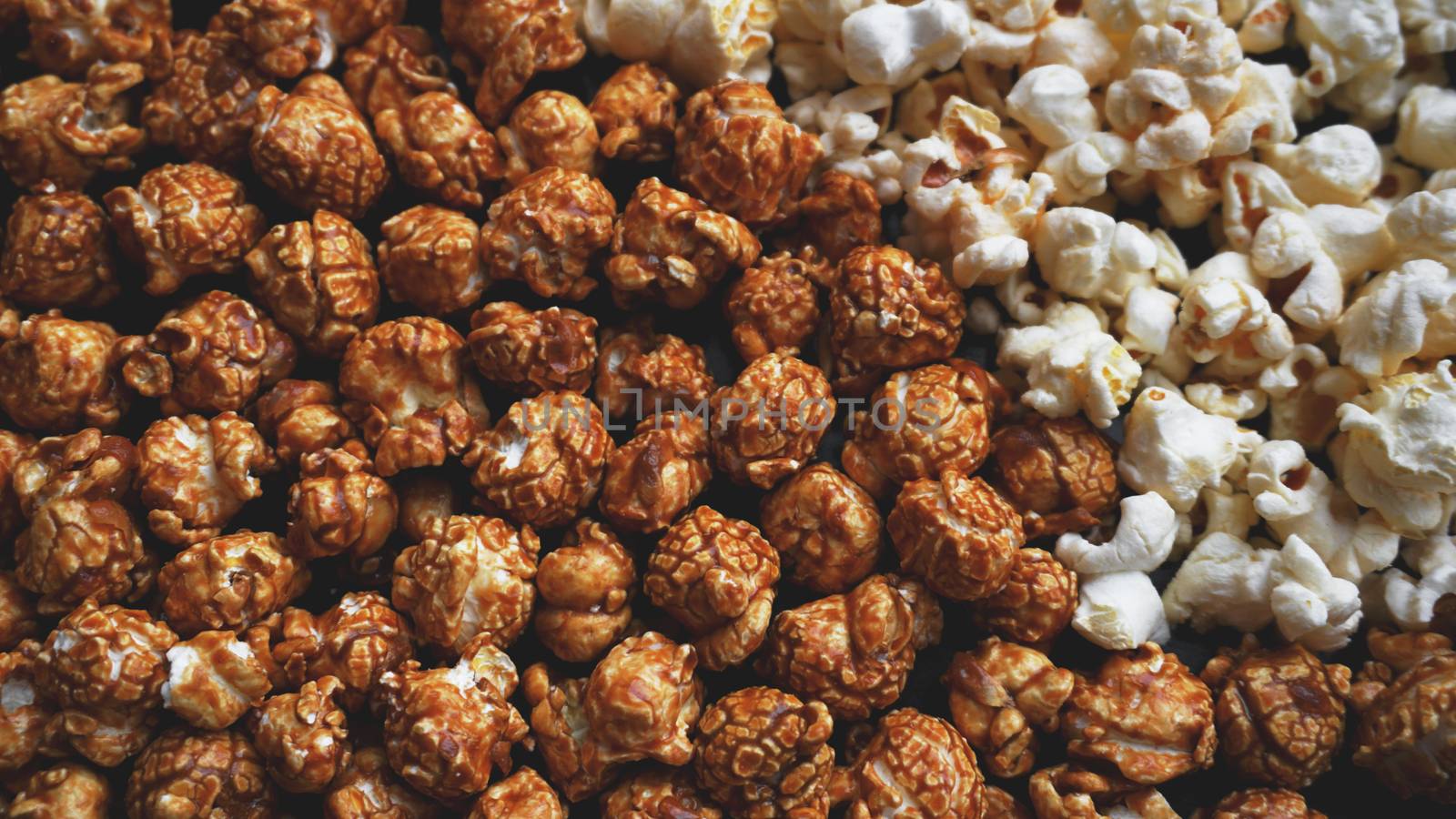 Assorted popcorn set background. Sweet and salty popcorn on black background. Still life, top view, flat lay. Concept cinema and entertainment