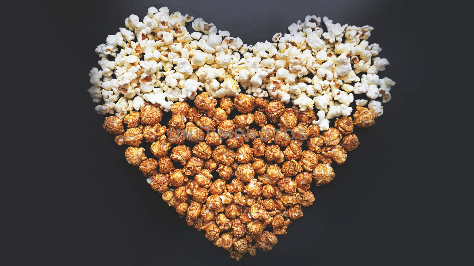 Love Cinema concept of popcorn arranged in a heart shape. Assorted popcorn by natali_brill