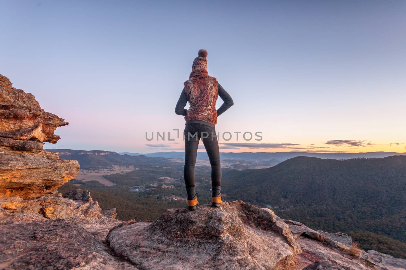 Bushwalker on summit of mountain with valley views by lovleah