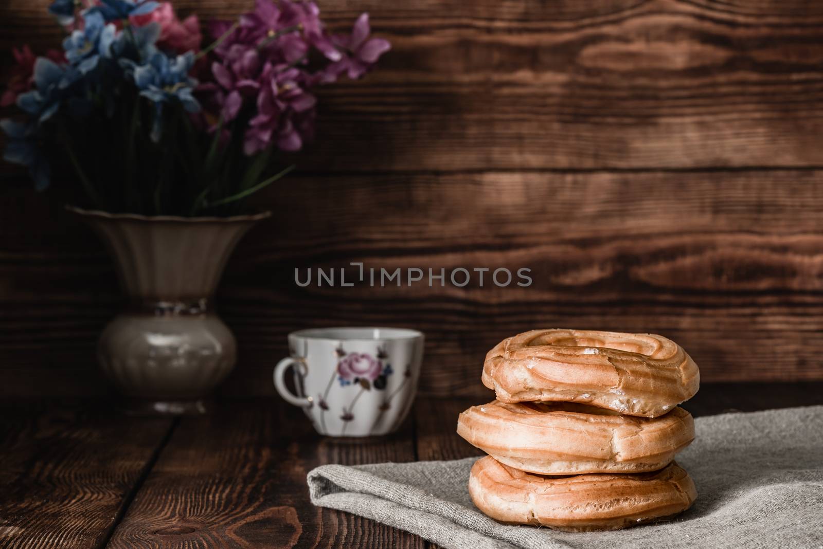 Eclairs stack on table with cup of coffee by Seva_blsv