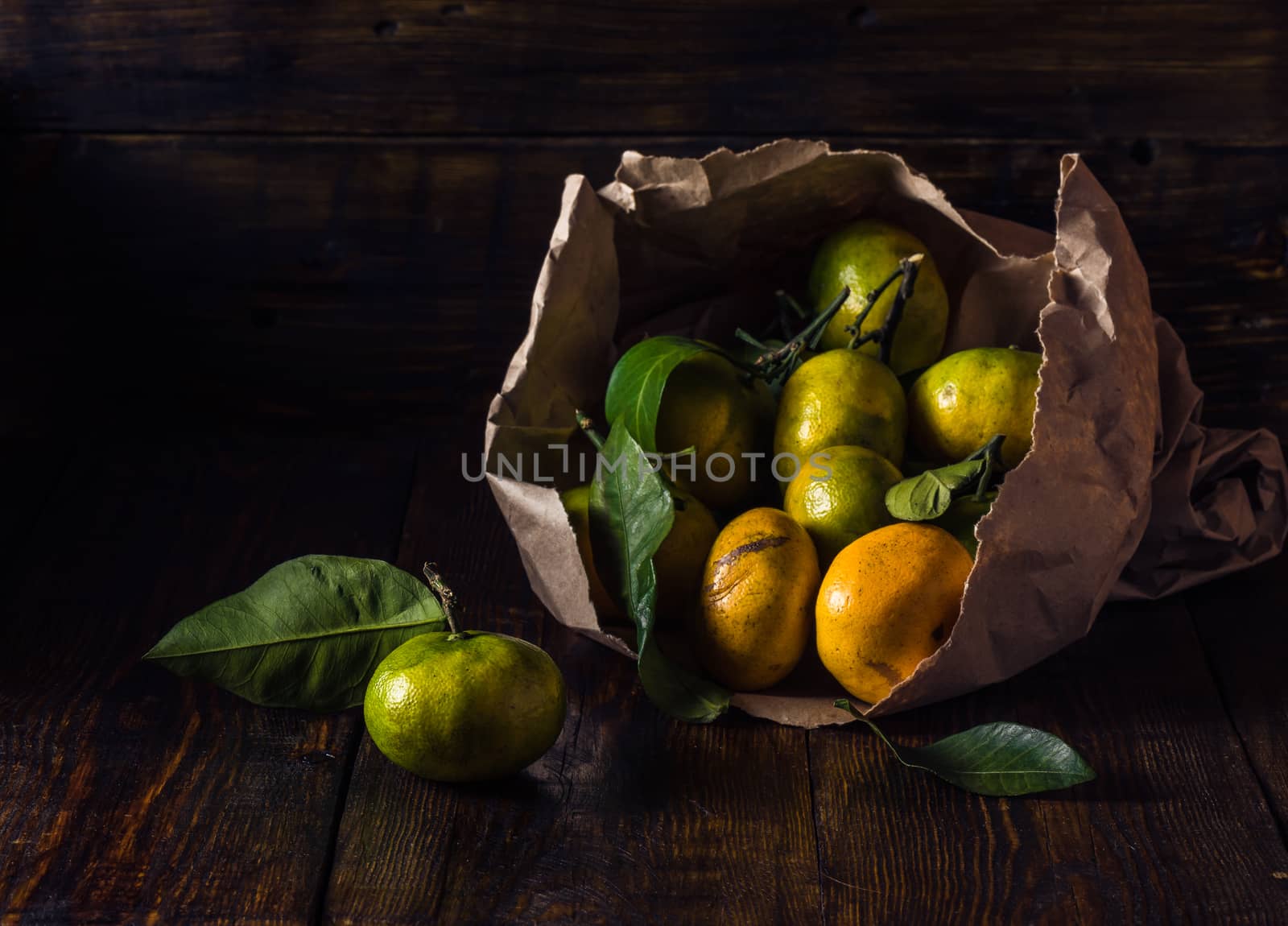 Ripe Tangerines with Leaves in Paper Bundle
