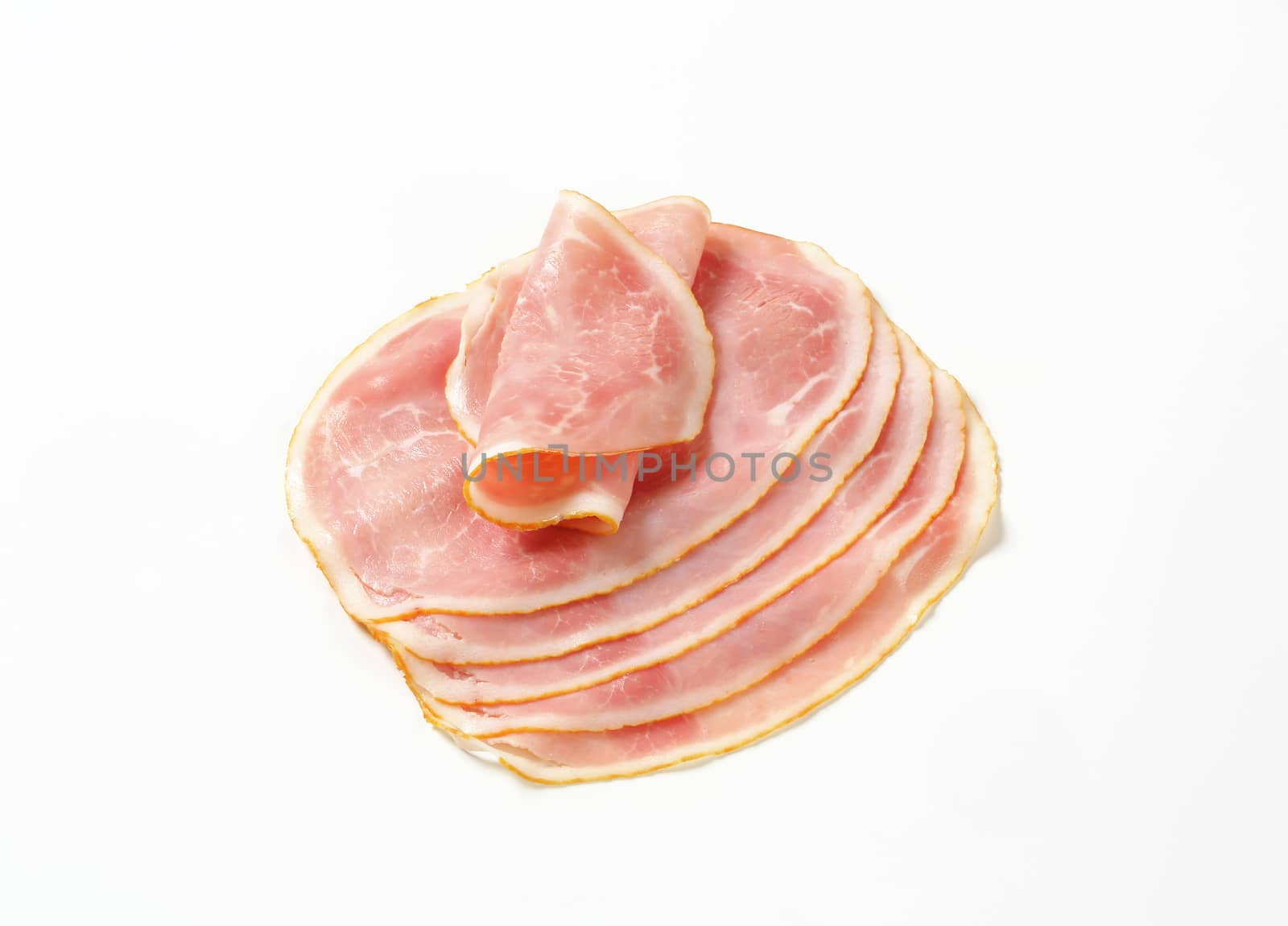 Thin slices of cooked ham on white background