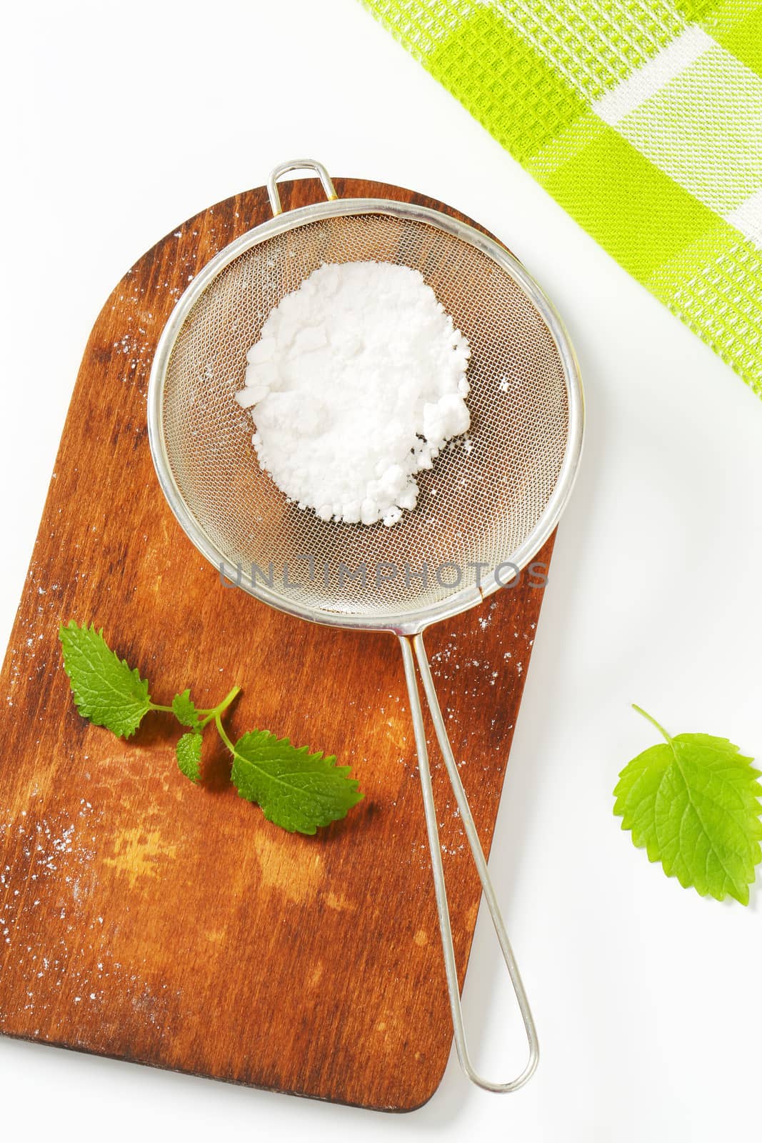 Powdered sugar in a sieve by Digifoodstock