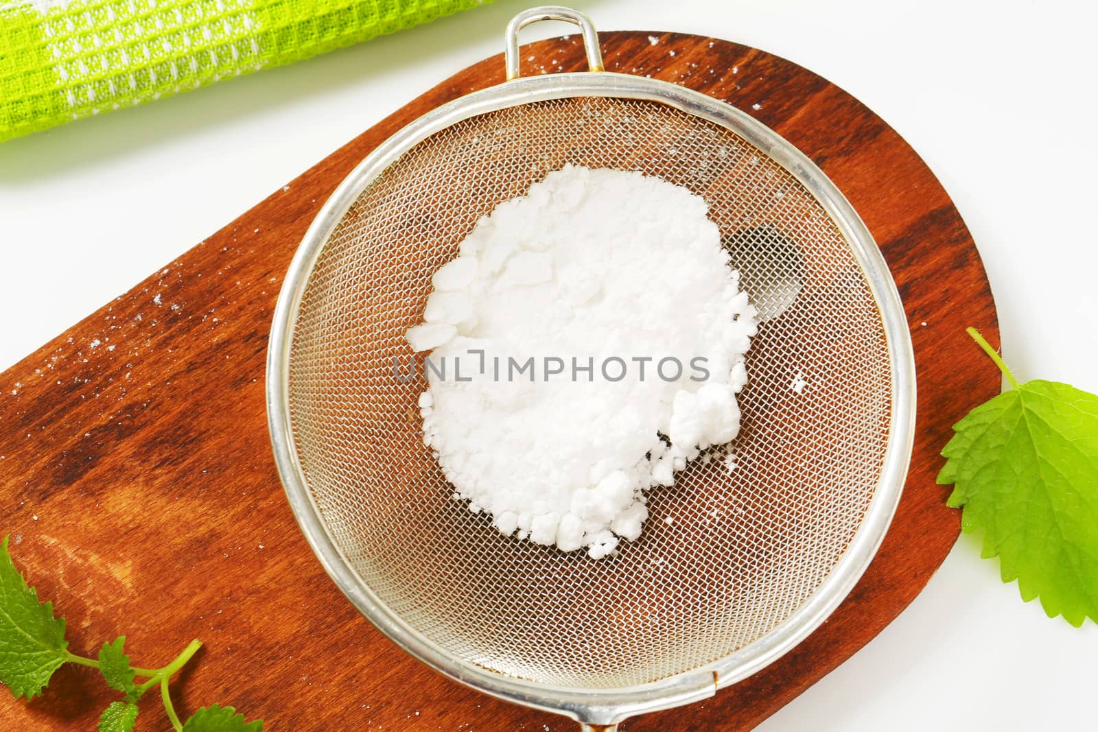 Powdered sugar in a metal sieve
