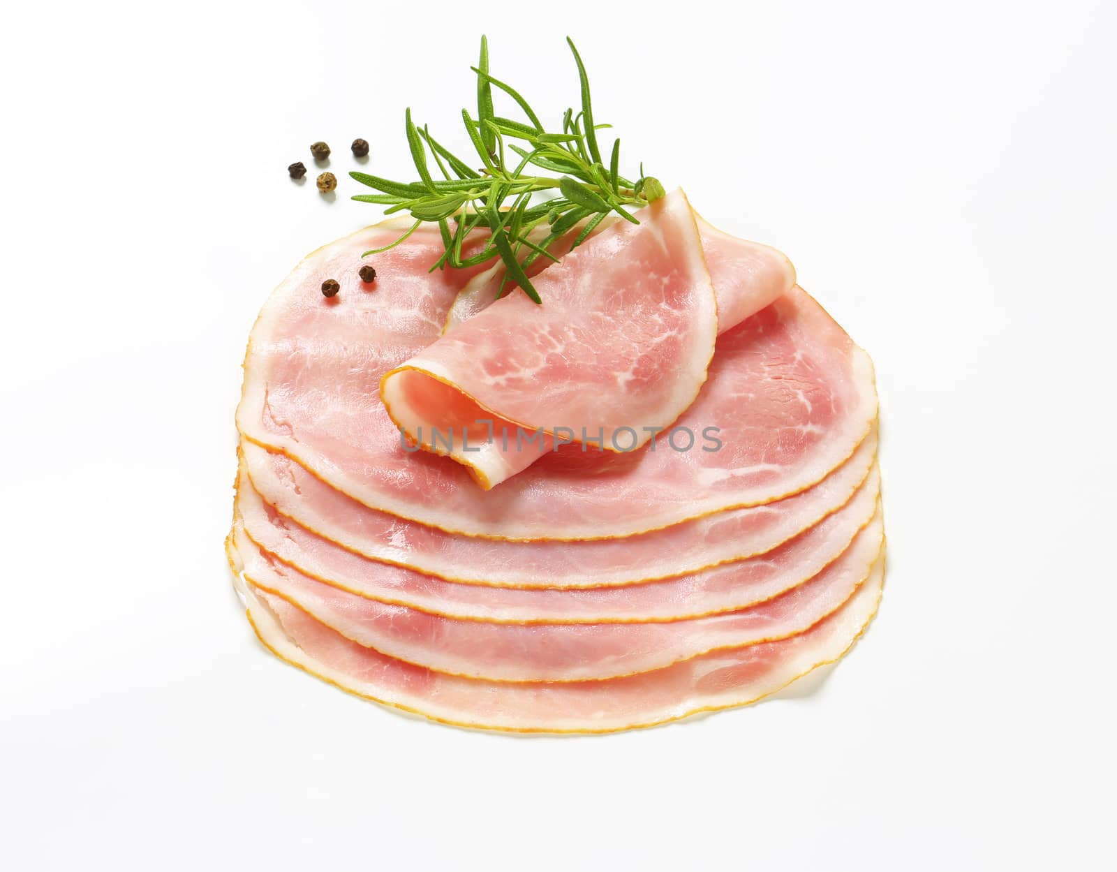 Thin slices of cooked ham on white background