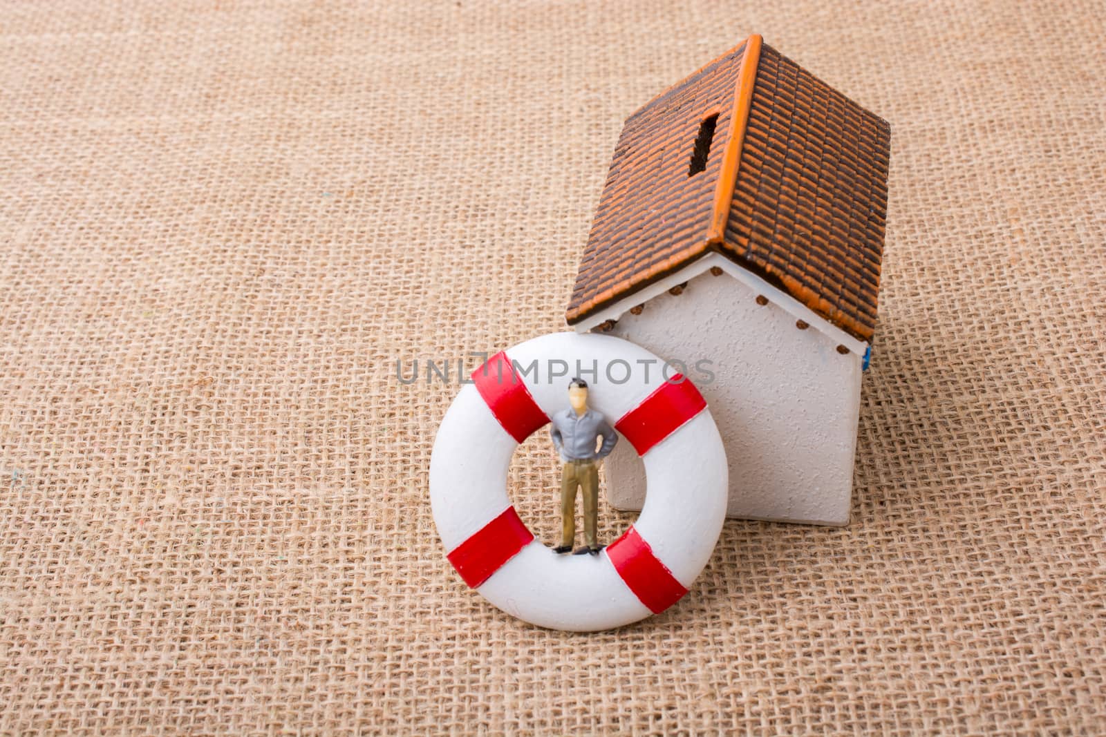 Model house and a life preserver with a man figure by berkay